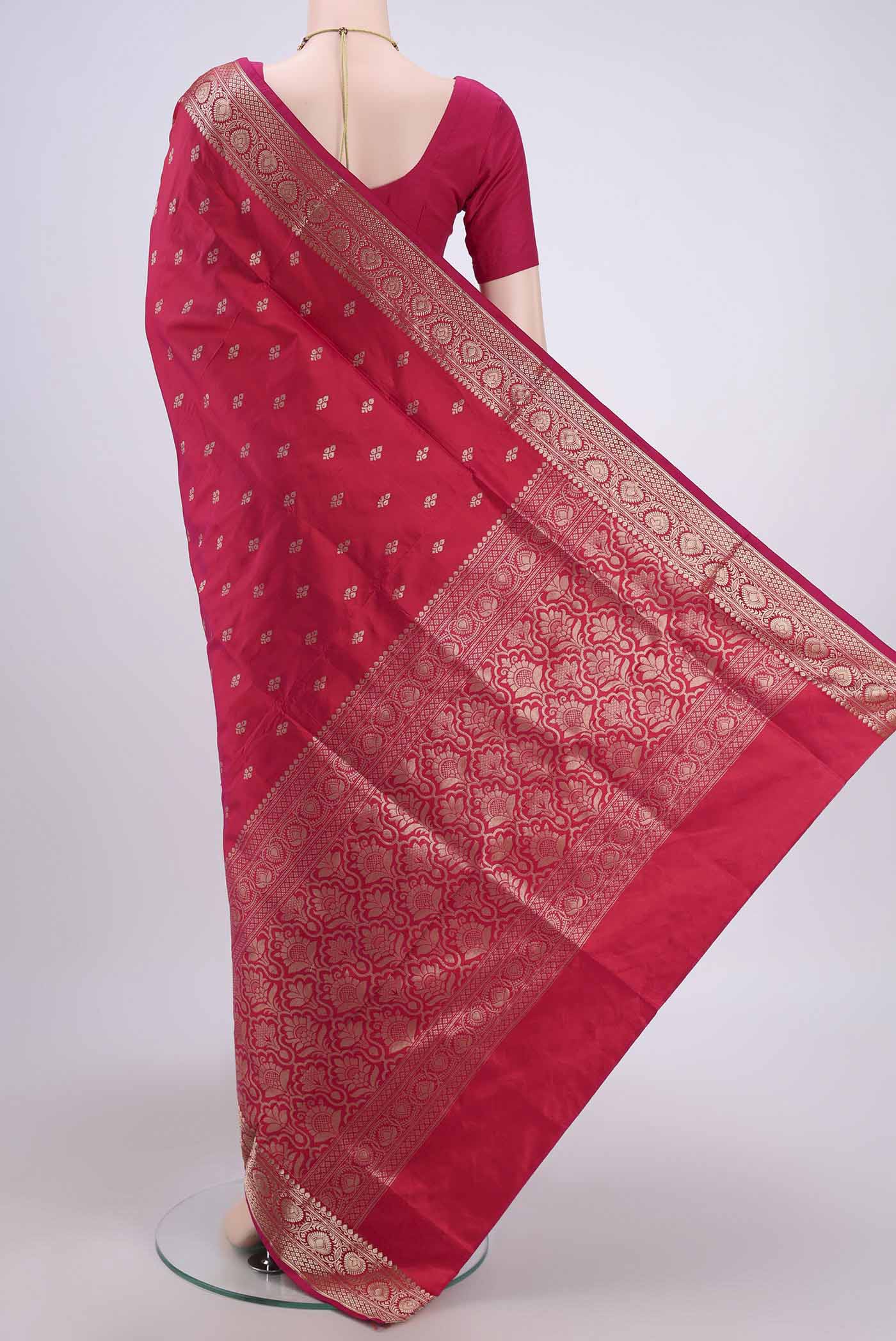 Flat view of Dark Pink Banarasi Katan Silk Saree with Zari Butta on the body and Zari Border. 