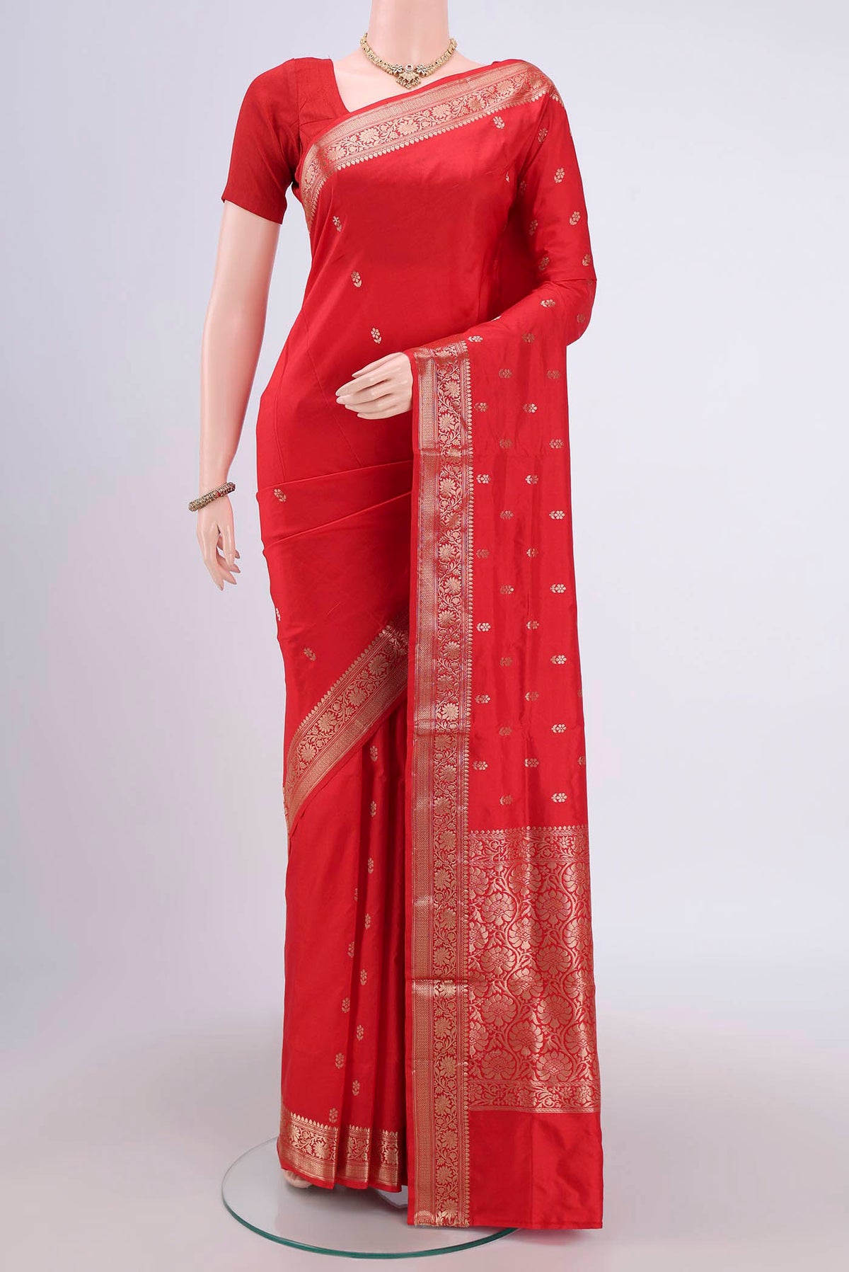 Imperial Red Banarasi Katan Silk Saree with Zari Butta on the body and Zari Border.  displayed on a mannequin