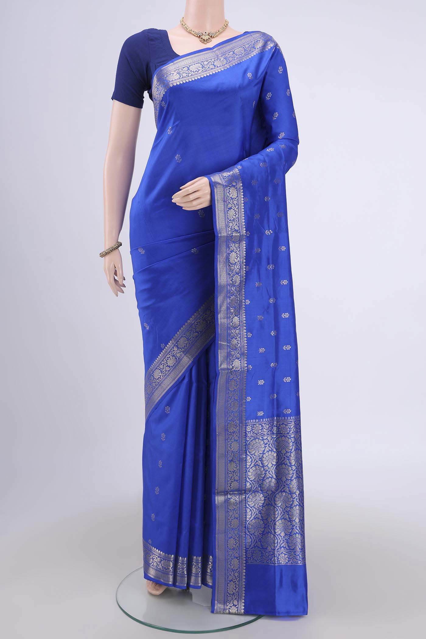Royal Blue Banarasi Katan Silk Saree with Zari Butta on the body and Zari Border.  displayed on a mannequin