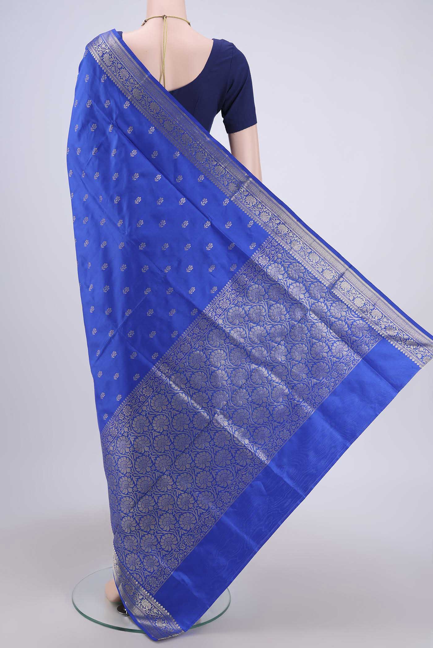 Flat view of Royal Blue Banarasi Katan Silk Saree with Zari Butta on the body and Zari Border. 