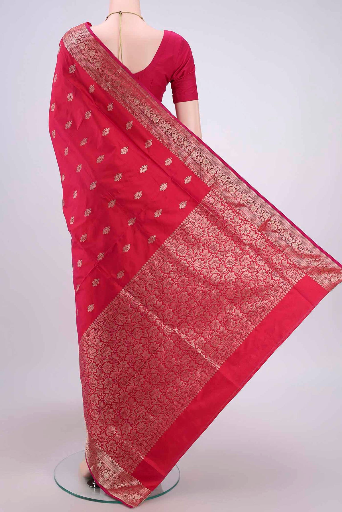 Flat view of Dark Pink Banarasi Katan Silk Saree with Zari Butta on the body and Zari Border. 