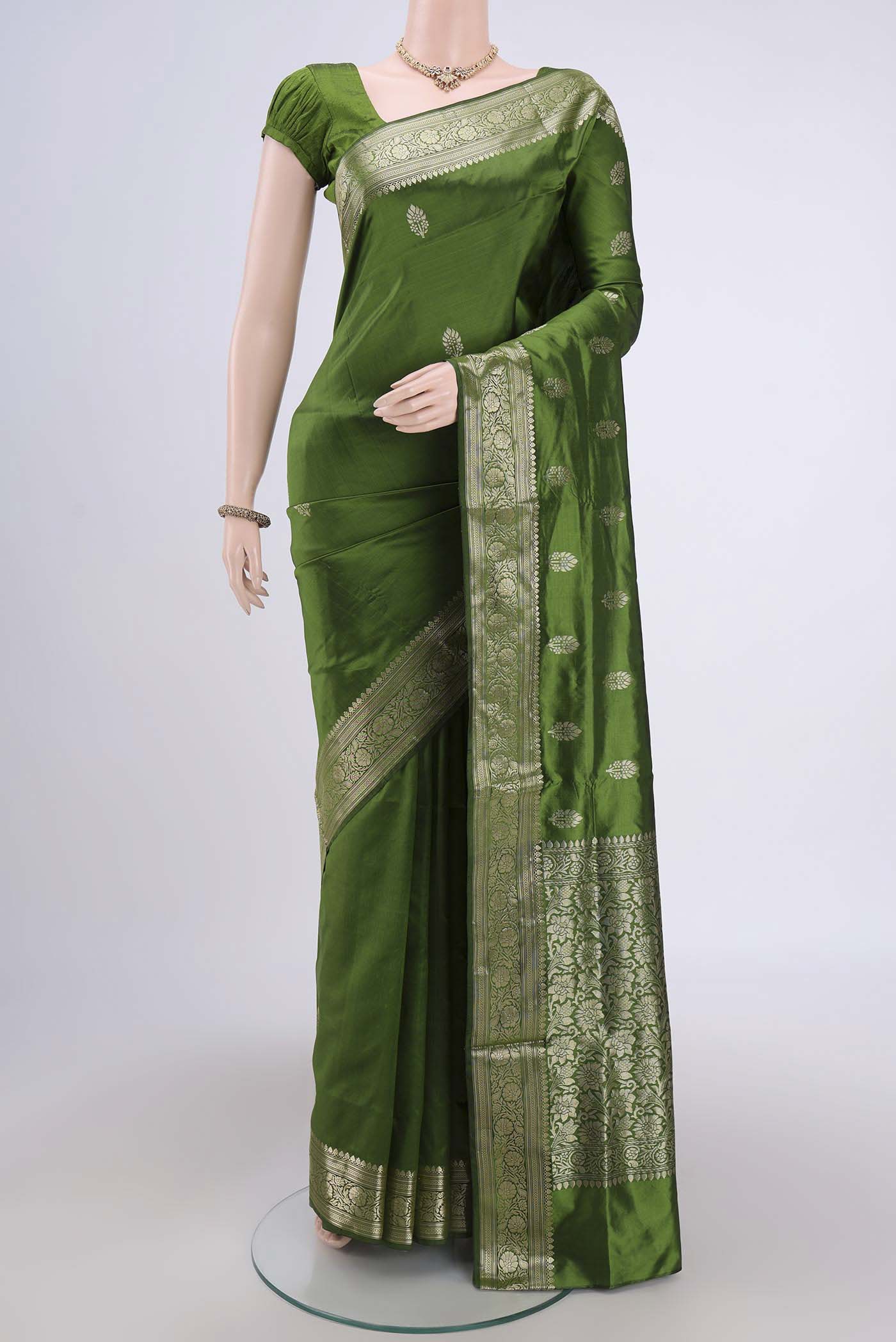 Green Banarasi Katan Silk Saree with Zari Butta on the body and Zari Border.  displayed on a mannequin