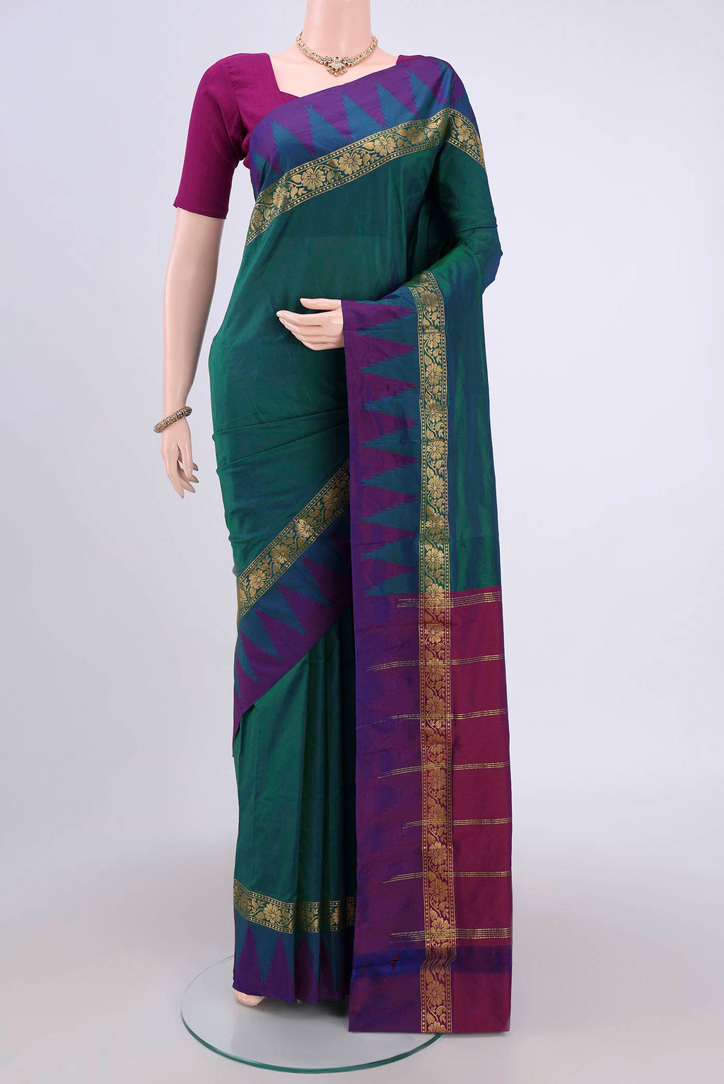 Bottle Green Bangalore Silk Saree with Plain Body and Zari Border.  displayed on a mannequin