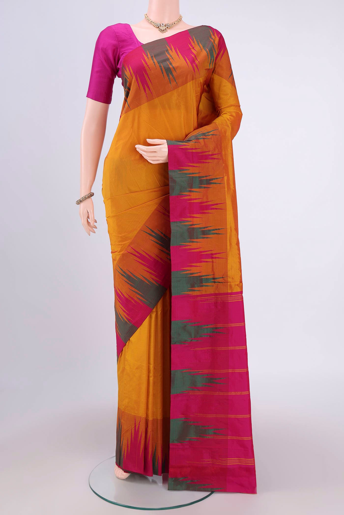 Mustard Bangalore Silk Saree with Plain Body and Temple Border.  displayed on a mannequin