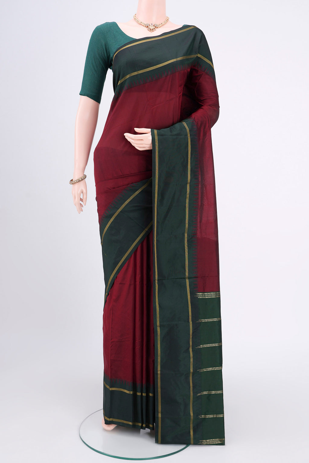 Maroon Blended Bangalore Silk Saree with Zari Butta on the body and Zari Border.  displayed on a mannequin