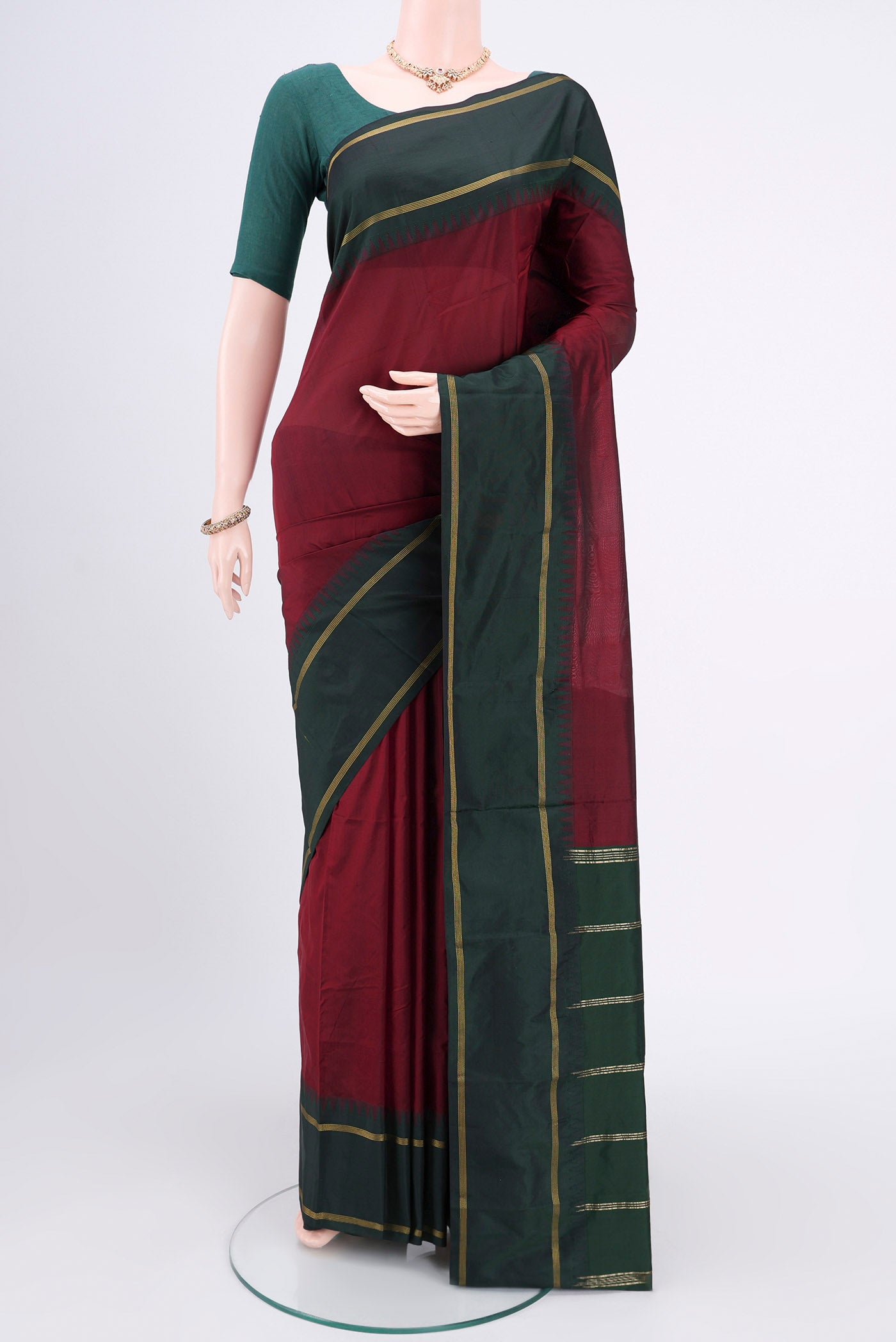 Maroon Blended Bangalore Silk Saree with Zari Butta on the body and Zari Border.  displayed on a mannequin