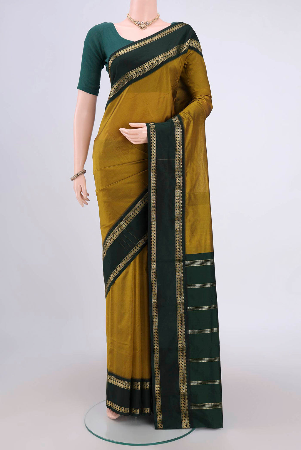 Mehandi Green Bangalore Silk Saree with Plain Body and Zari Border.  displayed on a mannequin