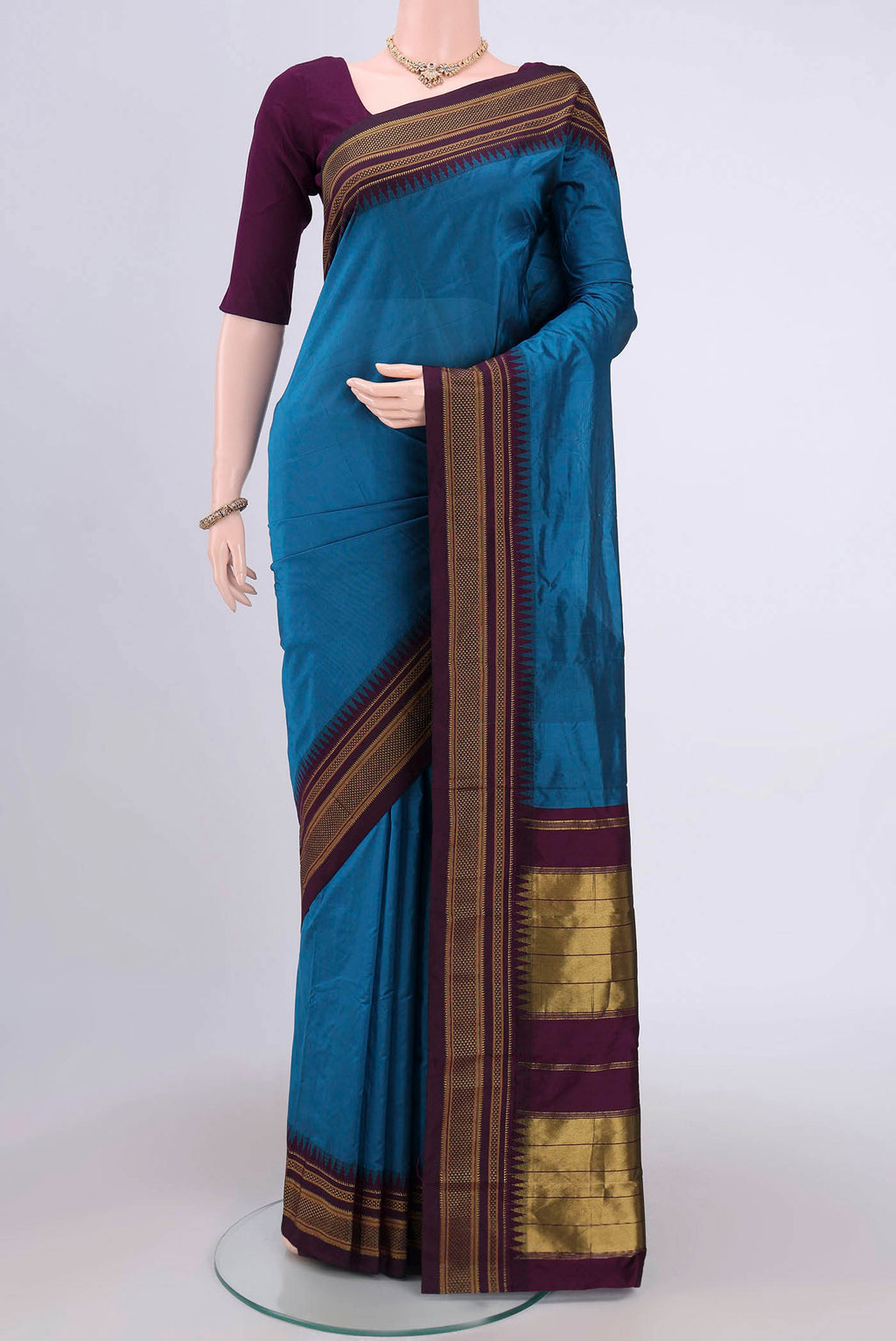 Blue Bangalore Silk Saree with Plain Body and Zari Border.  displayed on a mannequin
