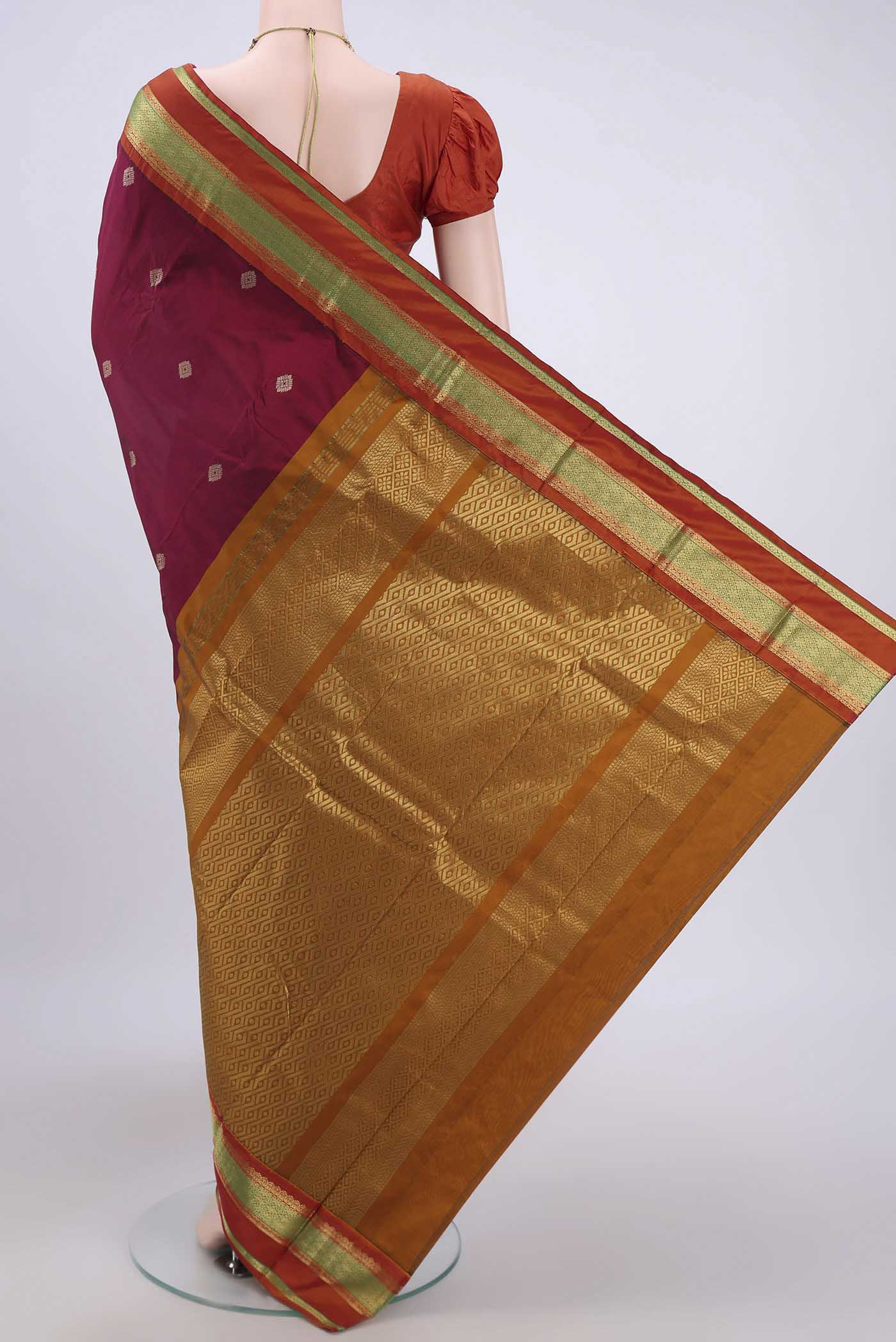 Flat view of Maroon Bangalore Silk Saree with Zari Butta on the body and Zari Border. 