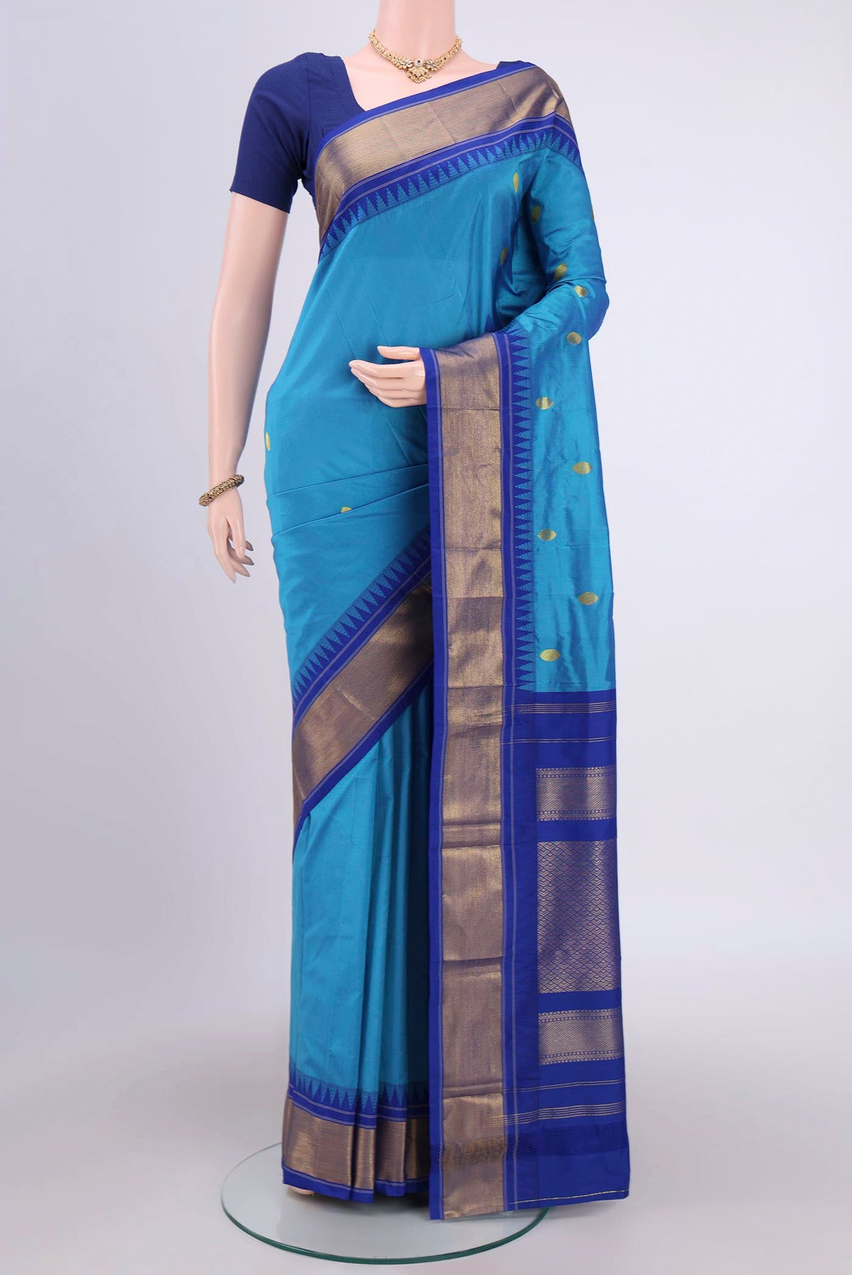 Blue Bangalore Silk Saree with Zari Butta on the body and Zari Border.  displayed on a mannequin