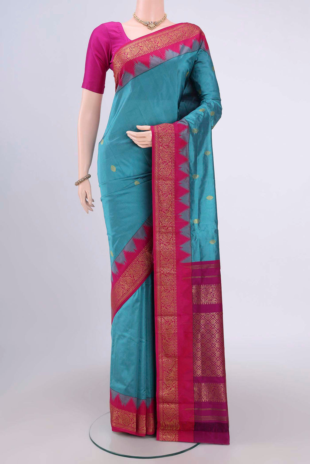 Blue Bangalore Silk Saree with Zari Butta on the body and Zari Border.  displayed on a mannequin