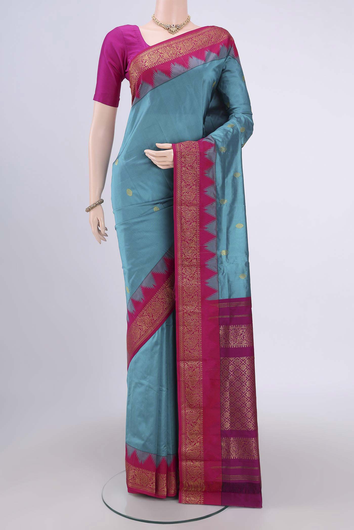 Blue Bangalore Silk Saree with Zari Butta on the body and Zari Border.  displayed on a mannequin