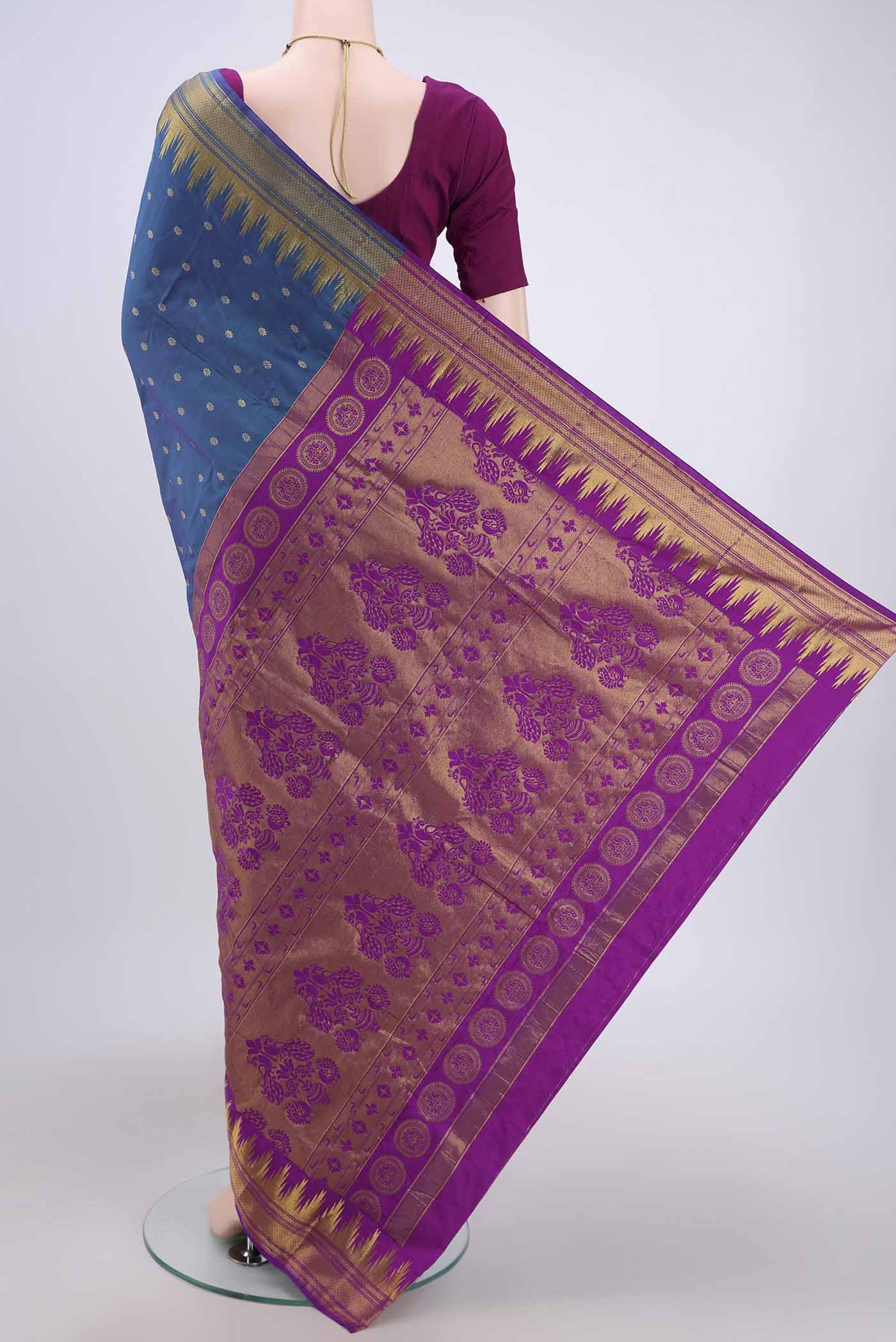 Flat view of Peacock Blue Bangalore Silk Saree with Zari Butta on the body and Zari Border. 