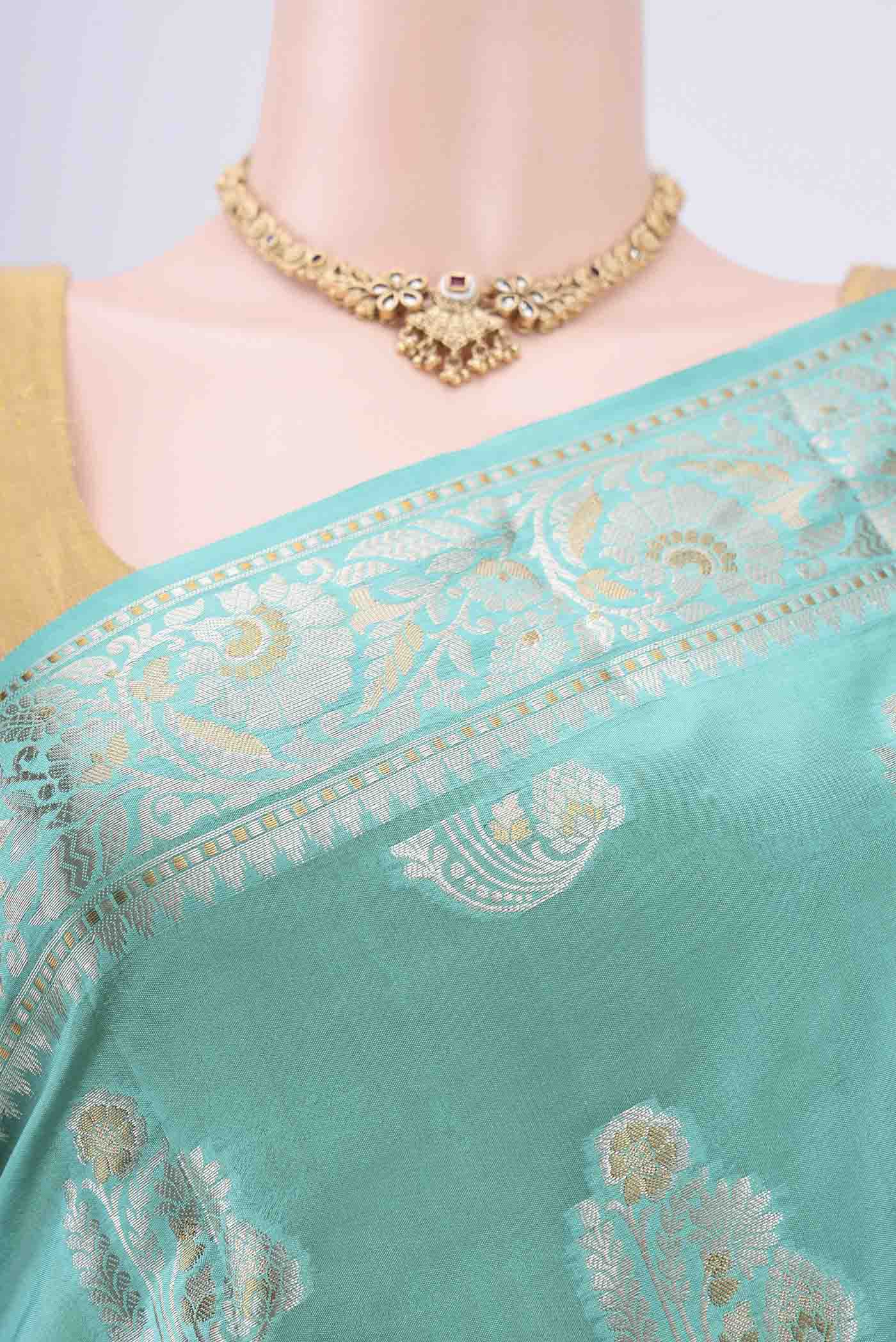 Border image of Turquoise Banarasi Raw Silk Saree with Zari Butta on the body and Zari Border. 