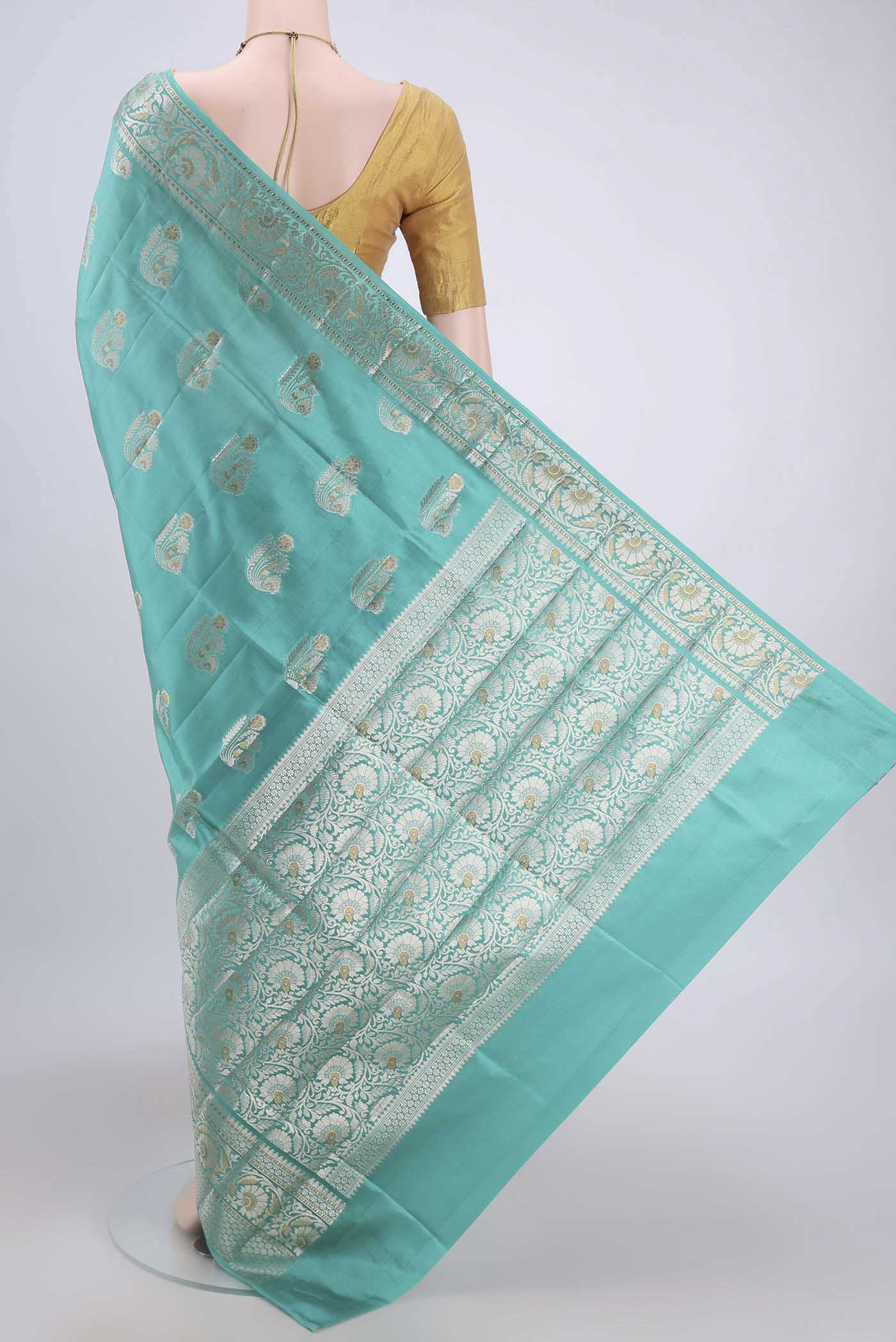 Flat view of Turquoise Banarasi Raw Silk Saree with Zari Butta on the body and Zari Border. 