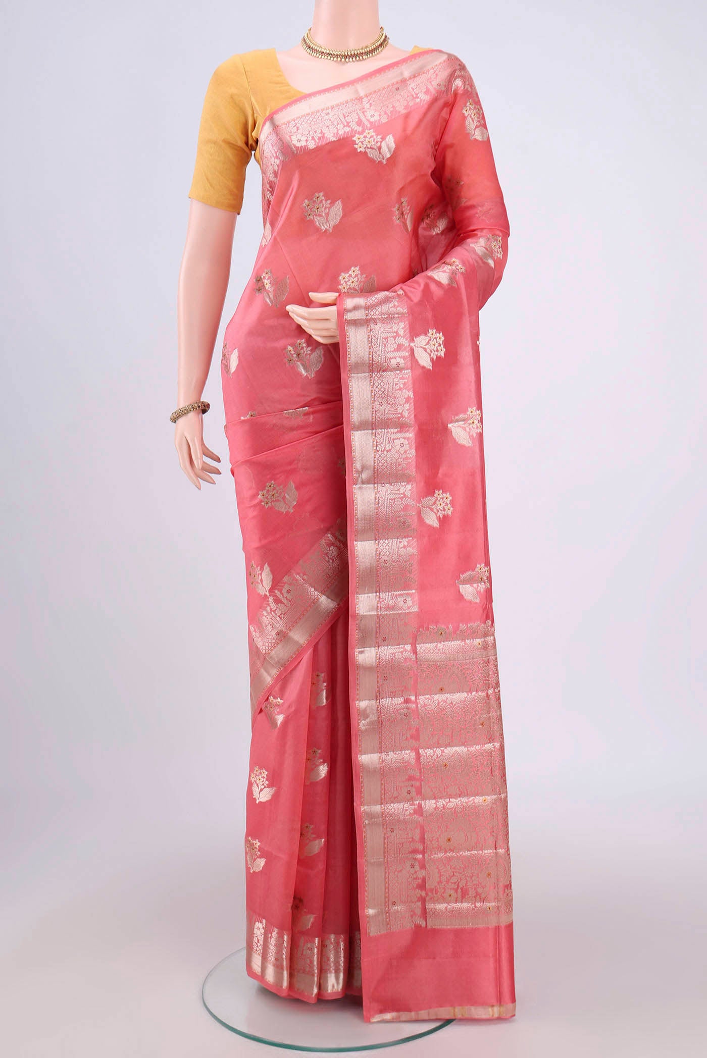 Peach Banarasi Raw Silk Saree with Zari Butta on the body and Zari Border.  displayed on a mannequin