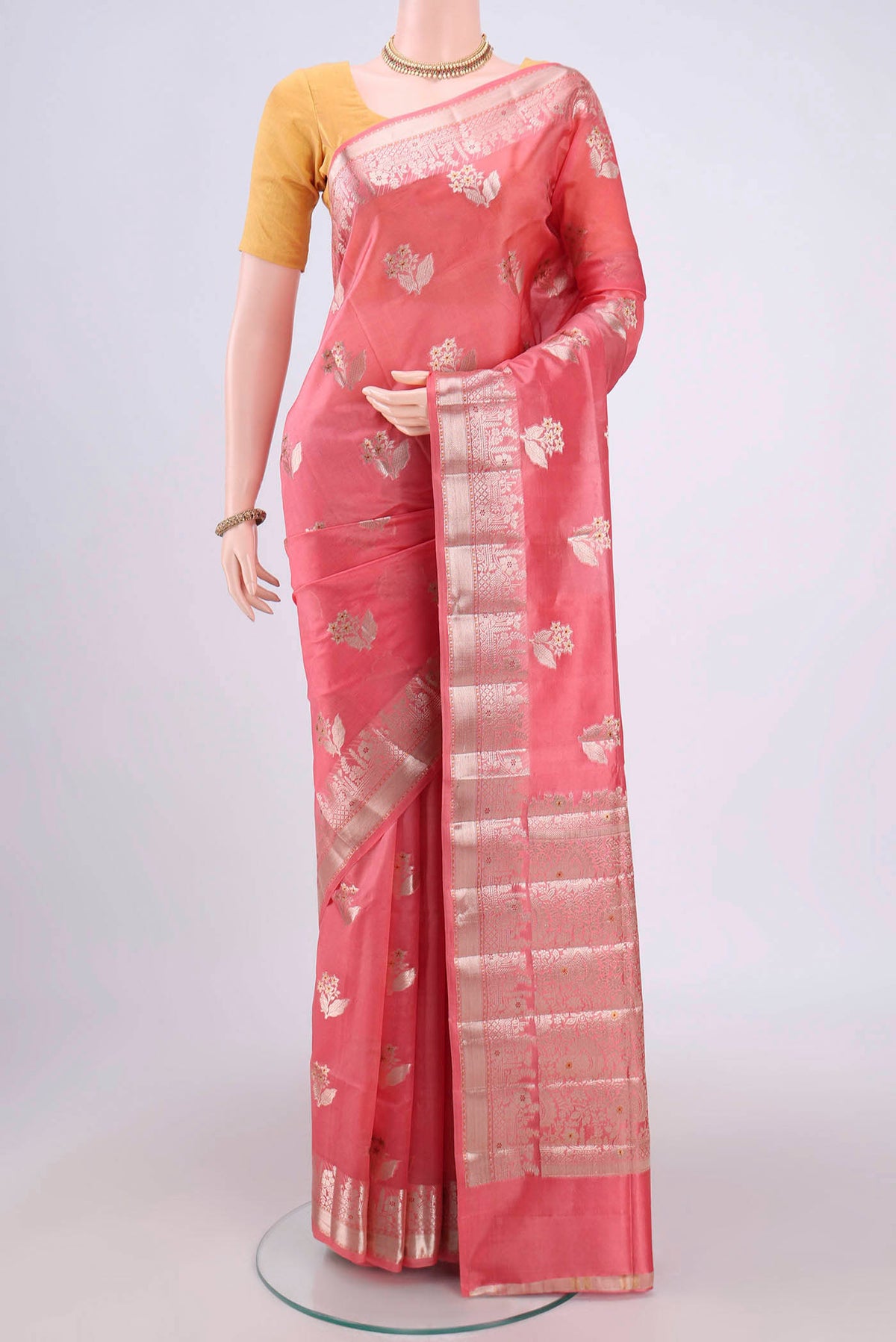 Peach Banarasi Raw Silk Saree with Zari Butta on the body and Zari Border.  displayed on a mannequin