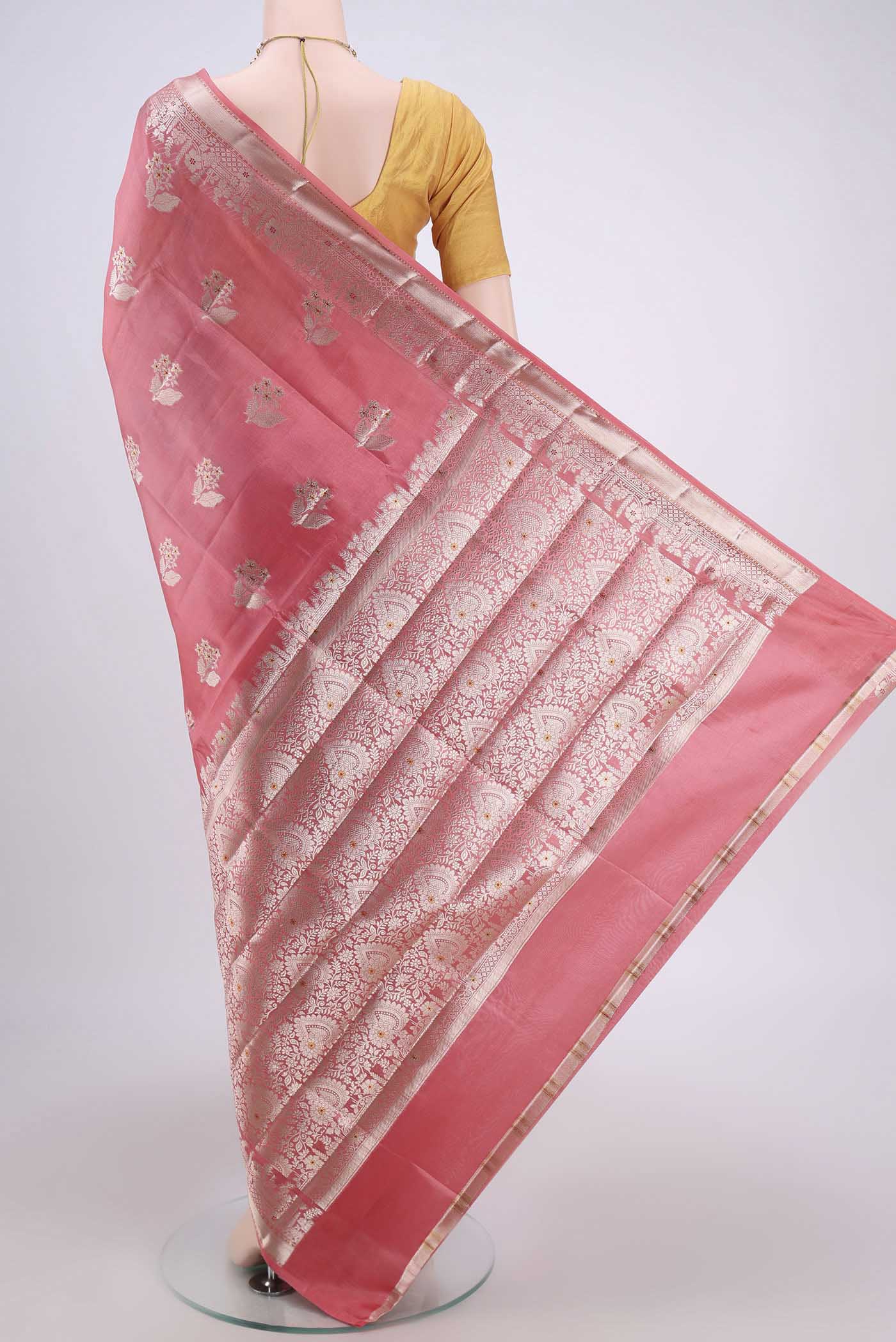 Flat view of Peach Banarasi Raw Silk Saree with Zari Butta on the body and Zari Border. 