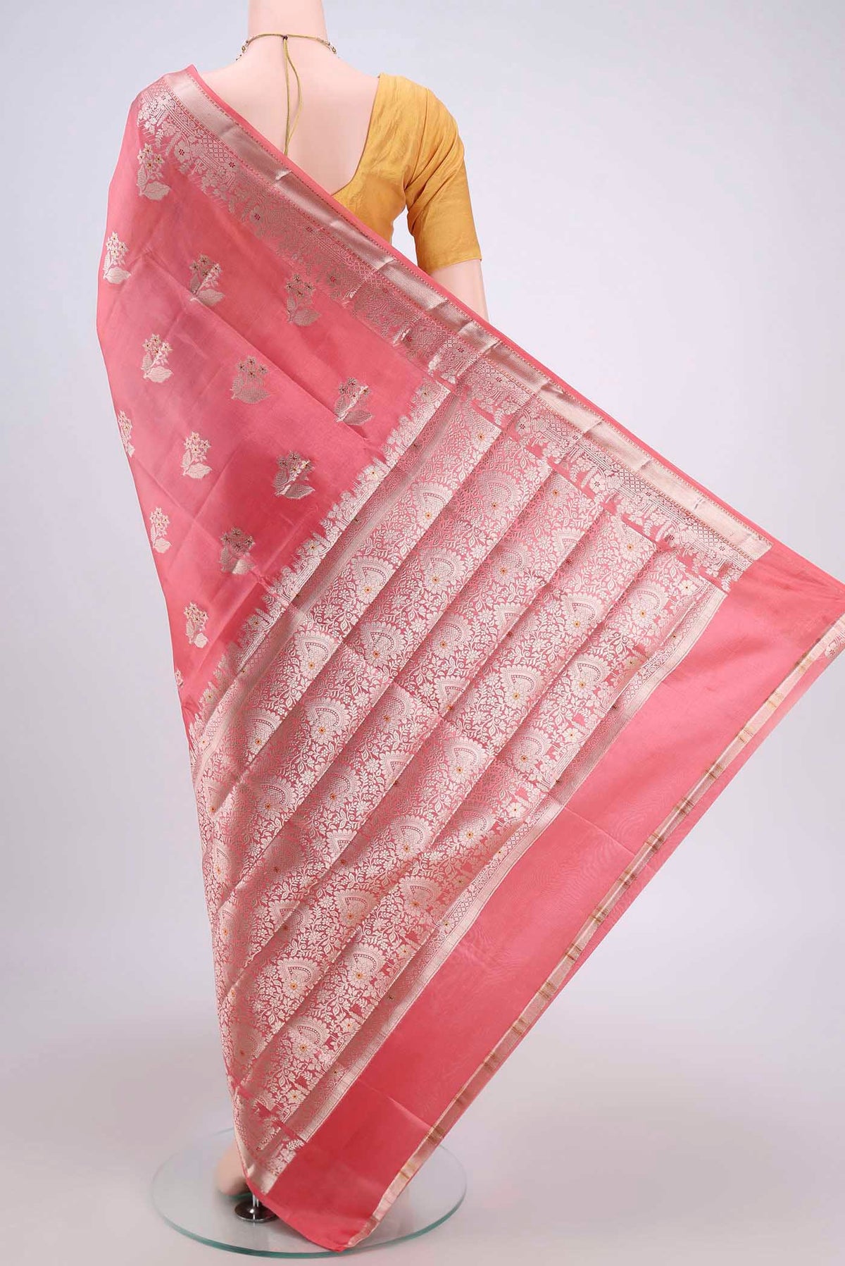 Flat view of Peach Banarasi Raw Silk Saree with Zari Butta on the body and Zari Border. 