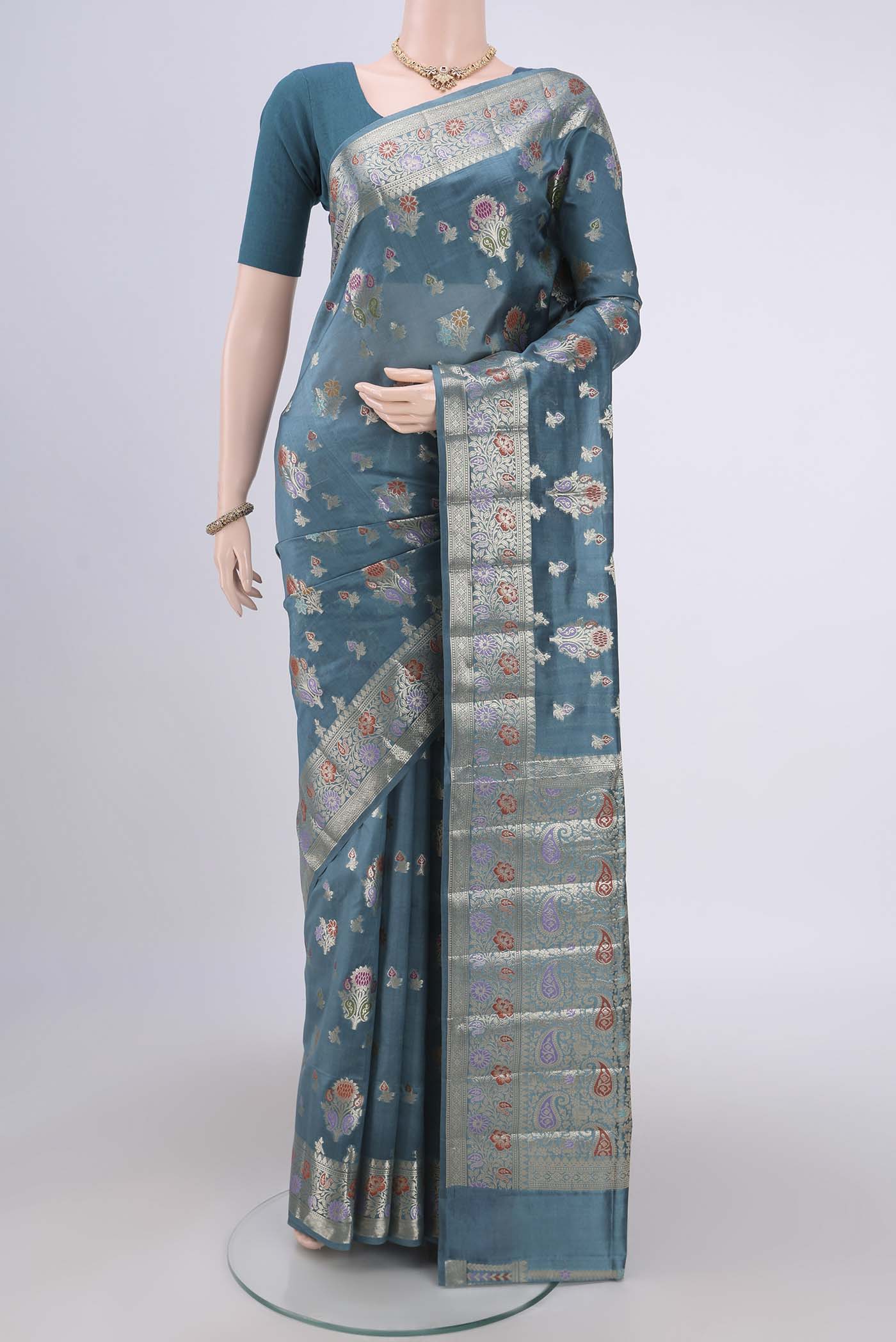 Blue Grey Banarasi Raw Silk Saree with Zari Butta on the body and Zari Border.  displayed on a mannequin