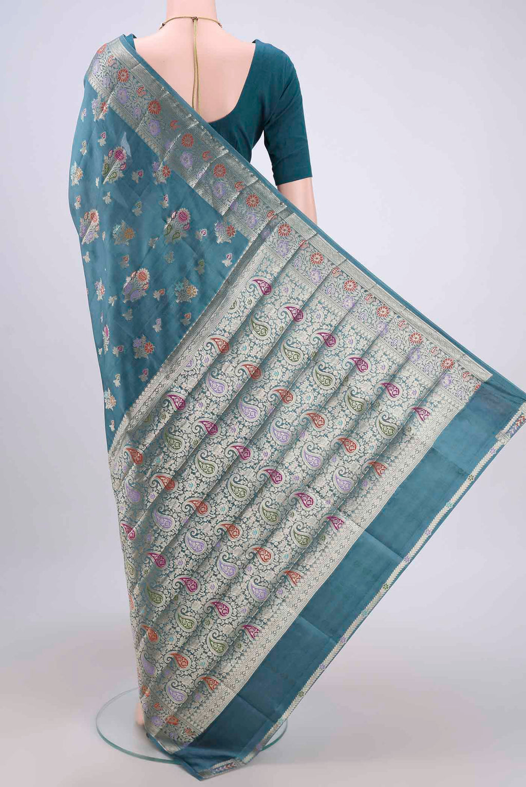 Flat view of Blue Grey Banarasi Raw Silk Saree with Zari Butta on the body and Zari Border. 