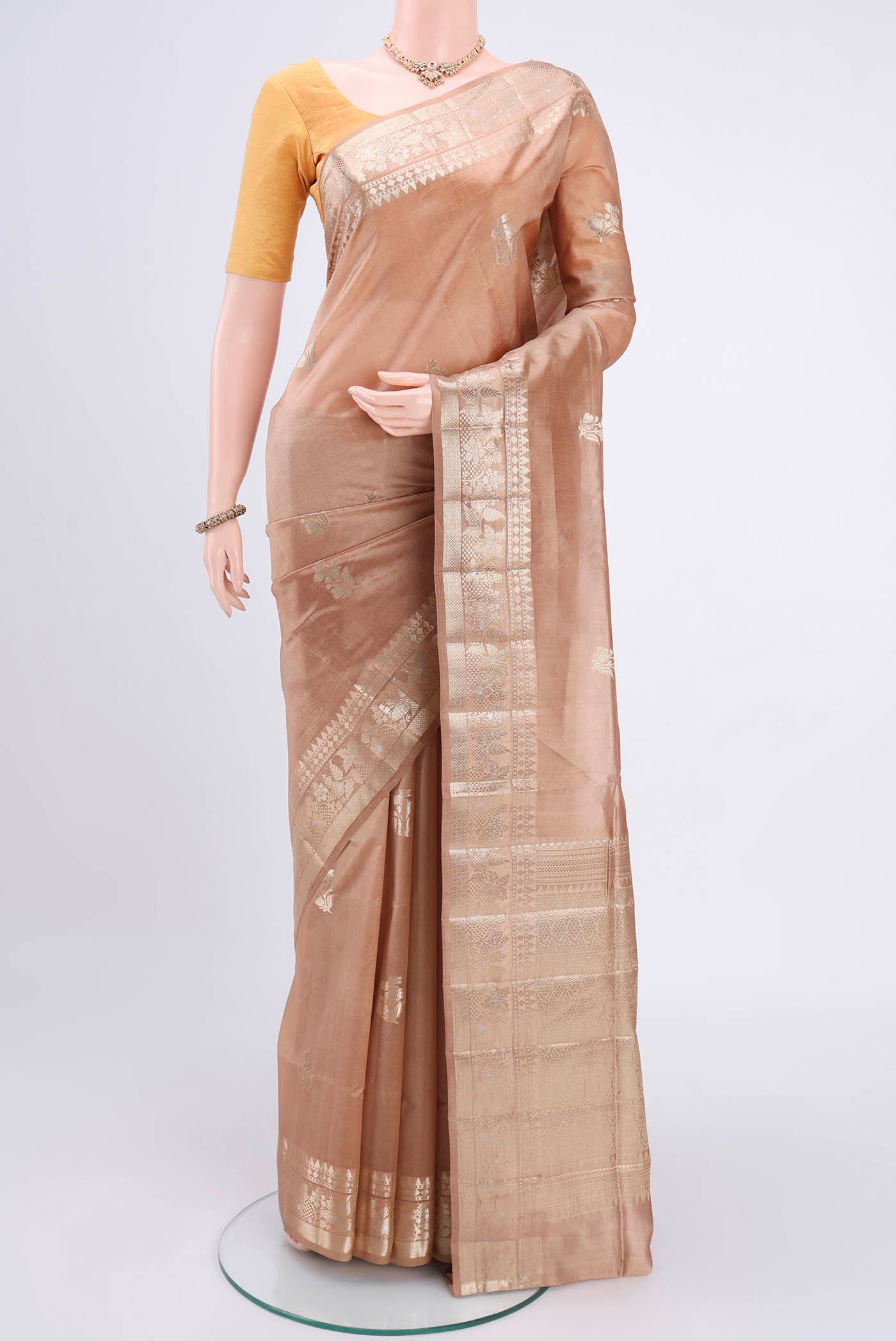 Dark Beige Banarasi Raw Silk Saree with Zari Butta on the body and Zari Border.  displayed on a mannequin
