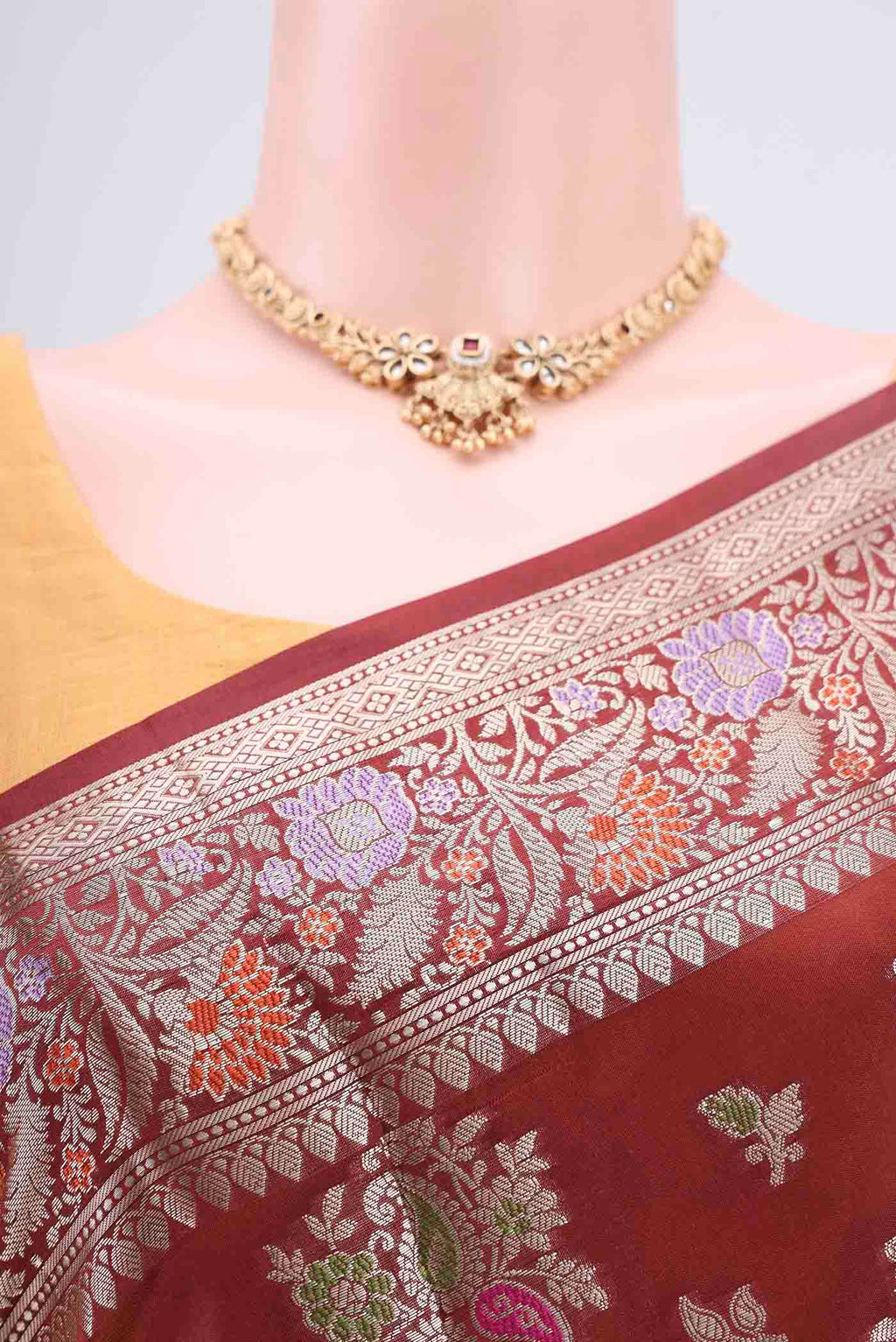 Border image of Maroon Banarasi Raw Silk Saree with Zari Butta on the body and Zari Border. 