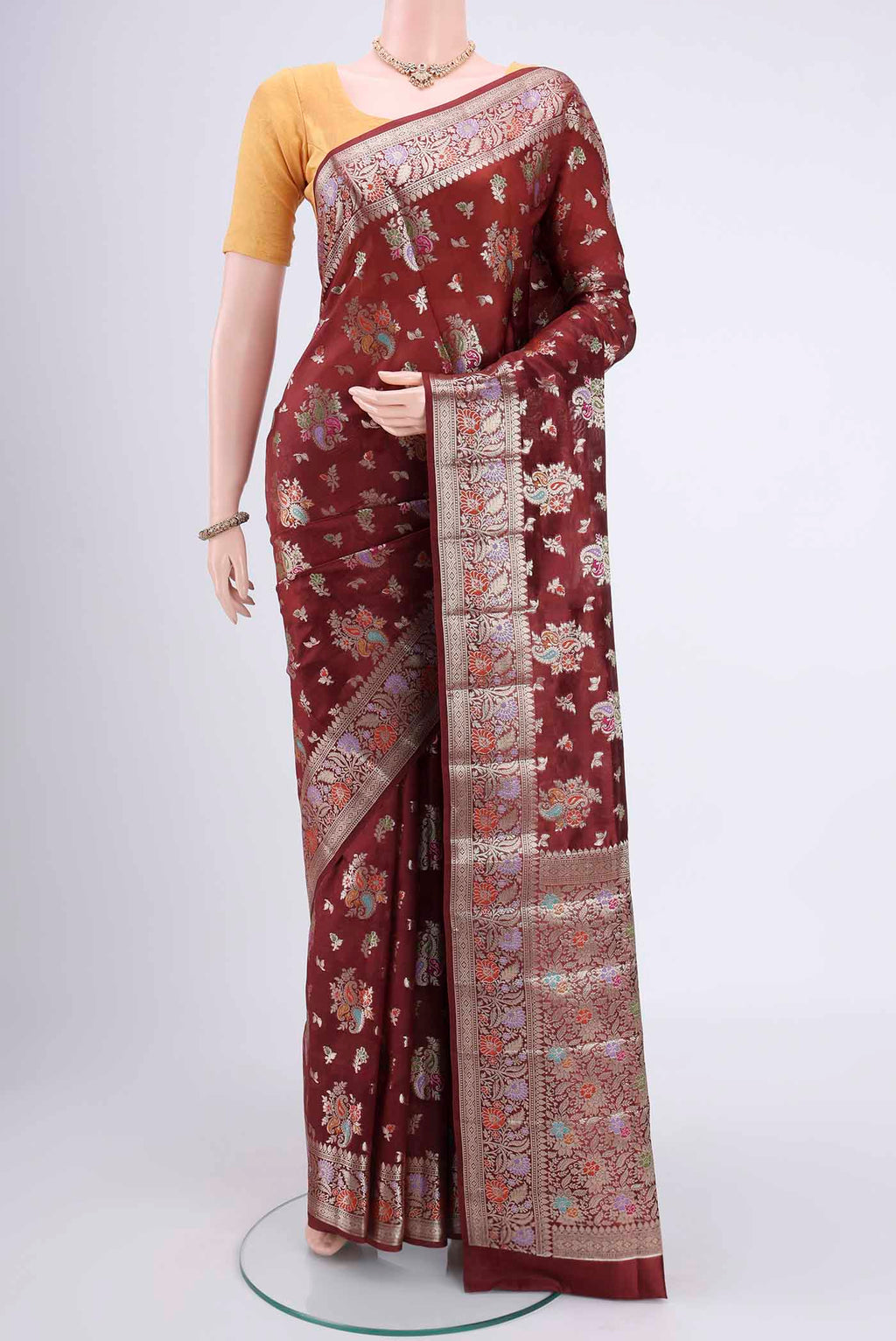 Maroon Banarasi Raw Silk Saree with Zari Butta on the body and Zari Border.  displayed on a mannequin