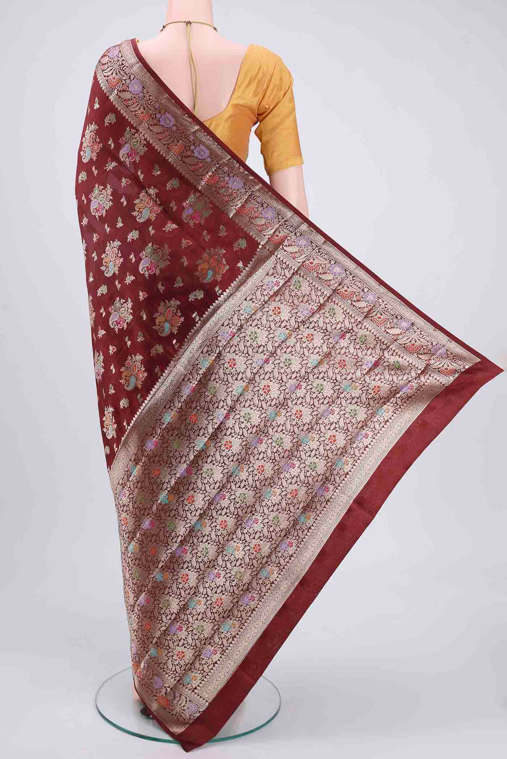 Flat view of Maroon Banarasi Raw Silk Saree with Zari Butta on the body and Zari Border. 