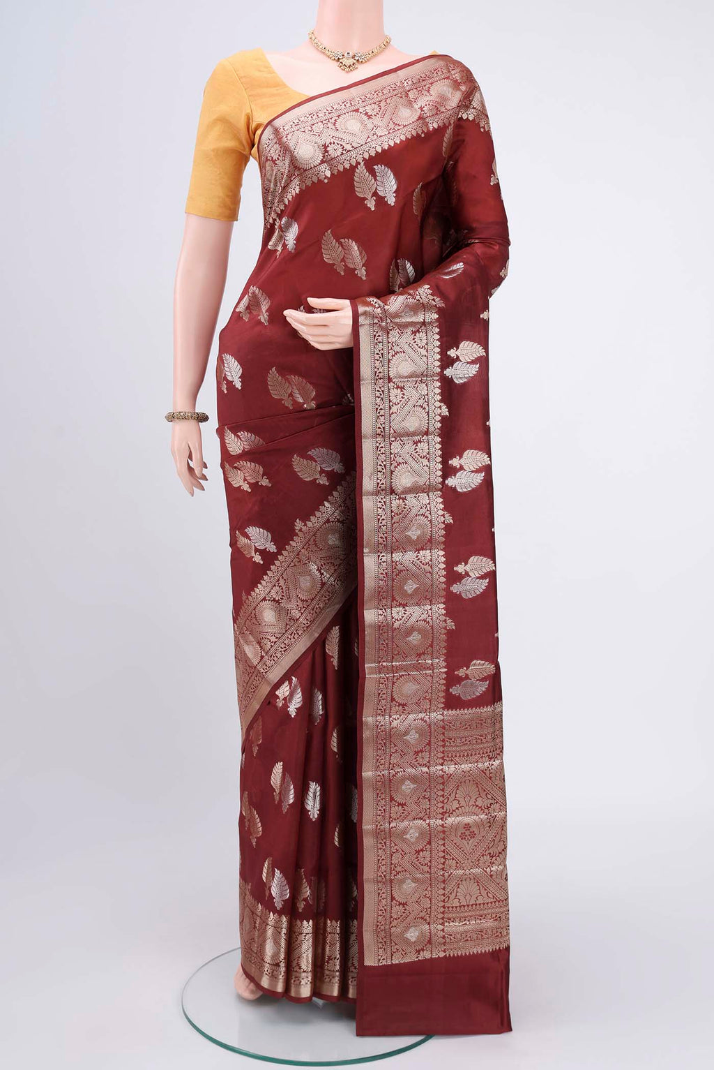 Brown Banarasi Raw Silk Saree with Zari Butta on the body and Zari Border.  displayed on a mannequin