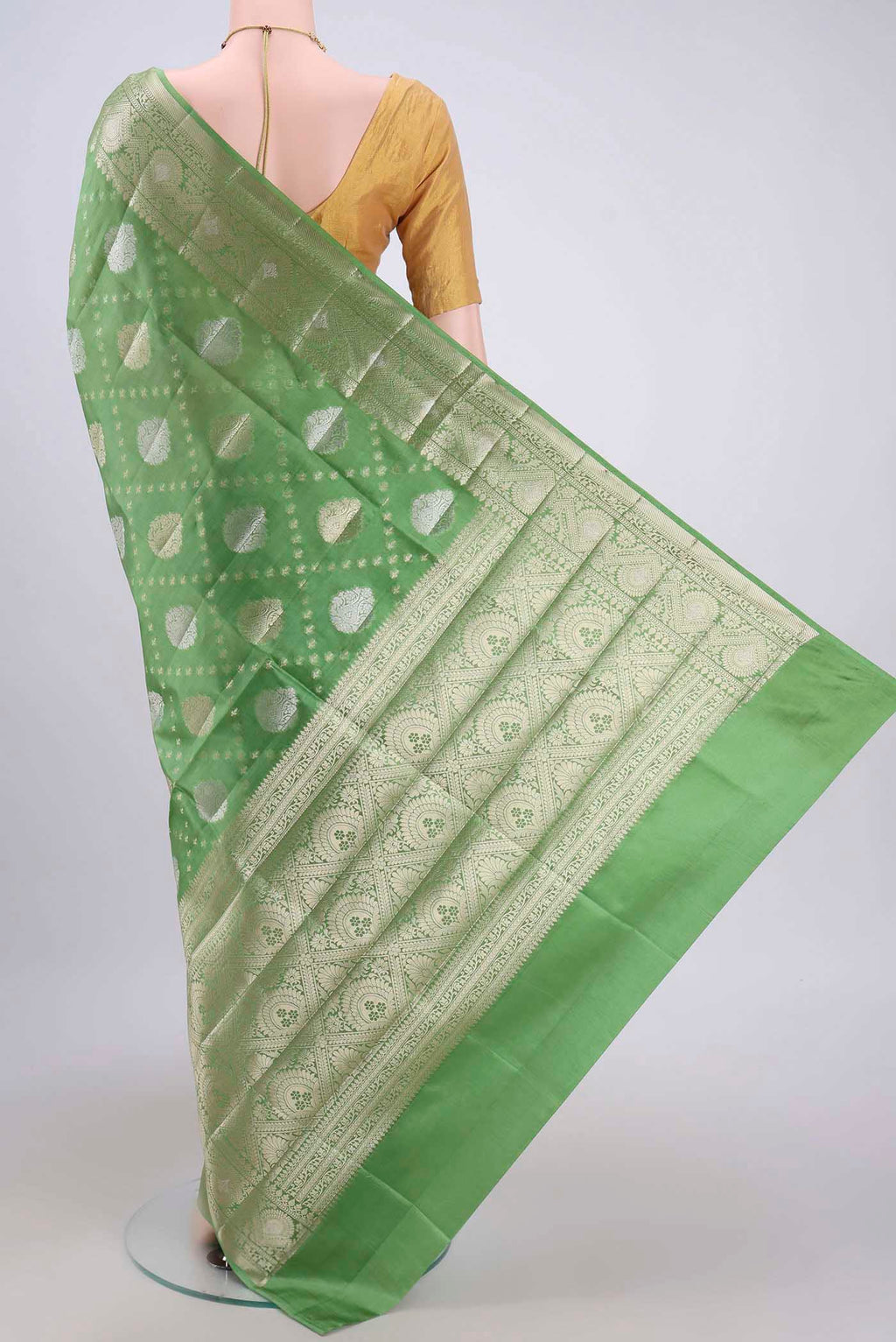 Flat view of Light Green Banarasi Raw Silk Saree with Zari Butta on the body and Zari Border. 