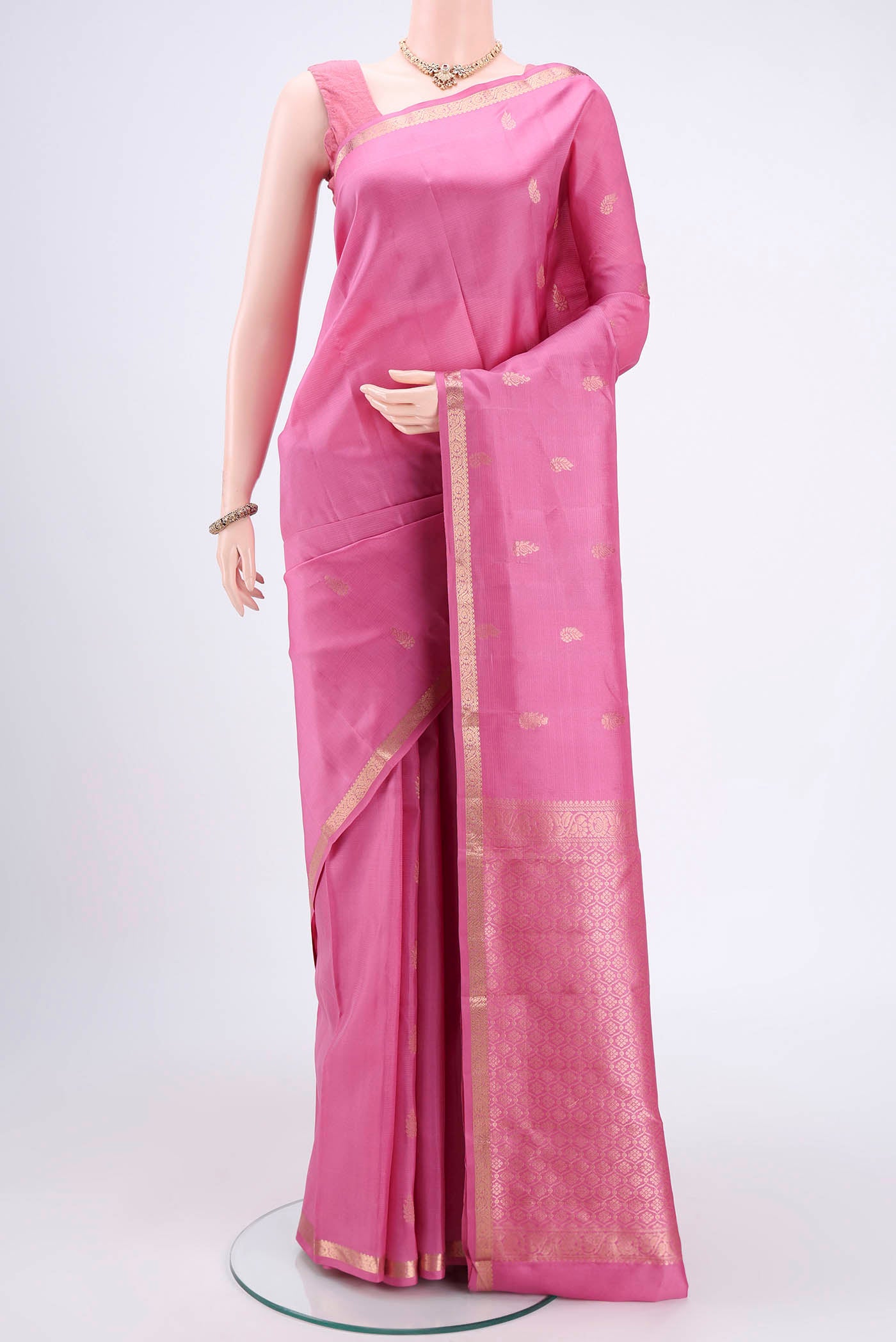Rose pink Kanjivaram Silk Saree with Zari Butta on the body and Zari Border.  displayed on a mannequin