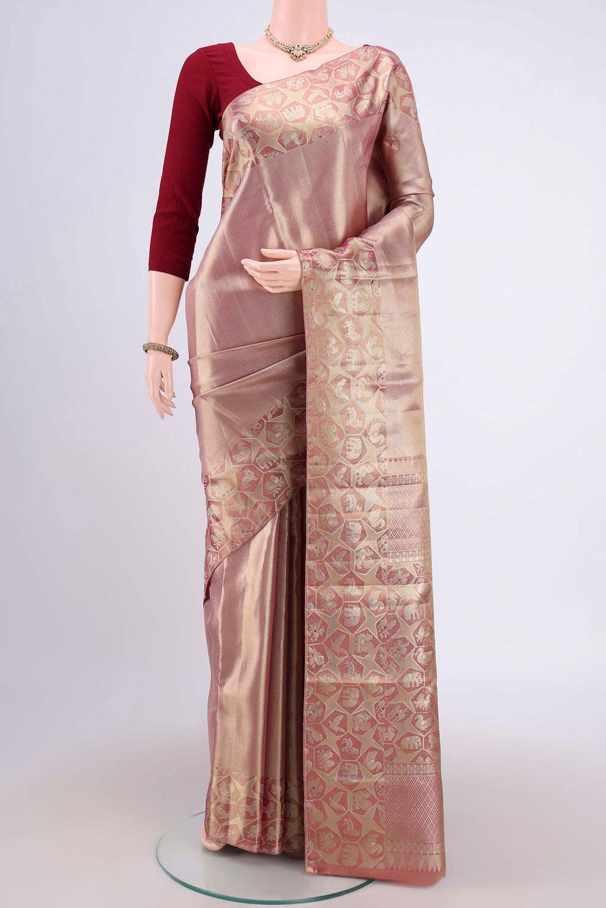 Gold with Red Dual Tone Kanjivaram Tissue Silk Saree with Zari Brocade on the body and Zari Border.  displayed on a mannequin