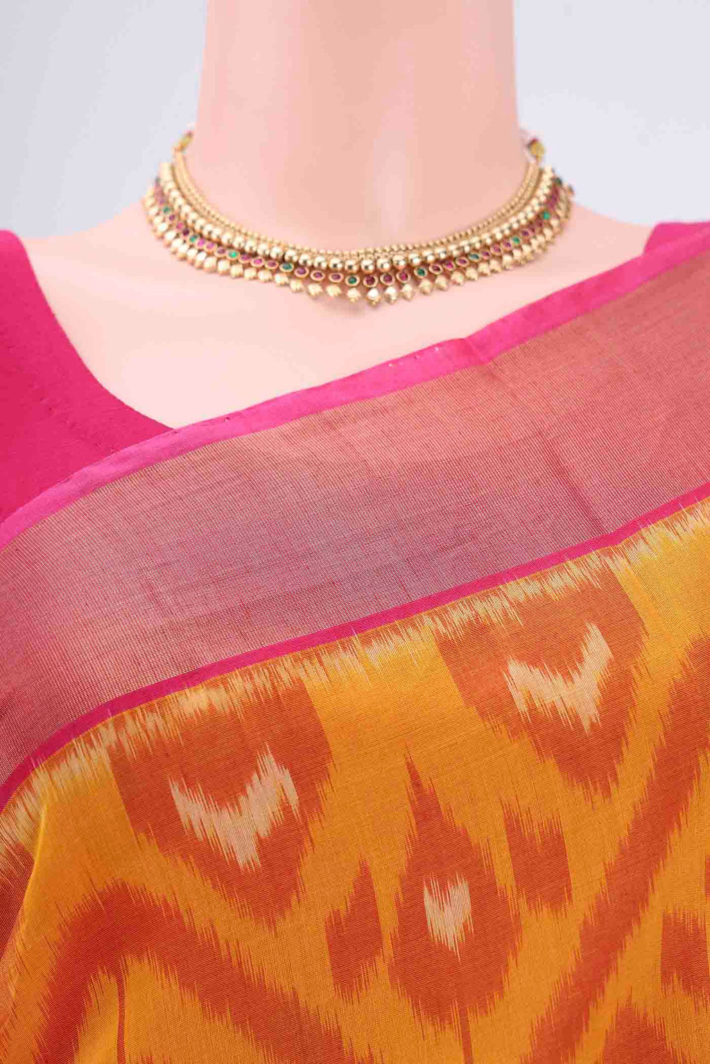Border image of Mustard Silk Cotton Saree with Ikat design on the body and Zari Border. 