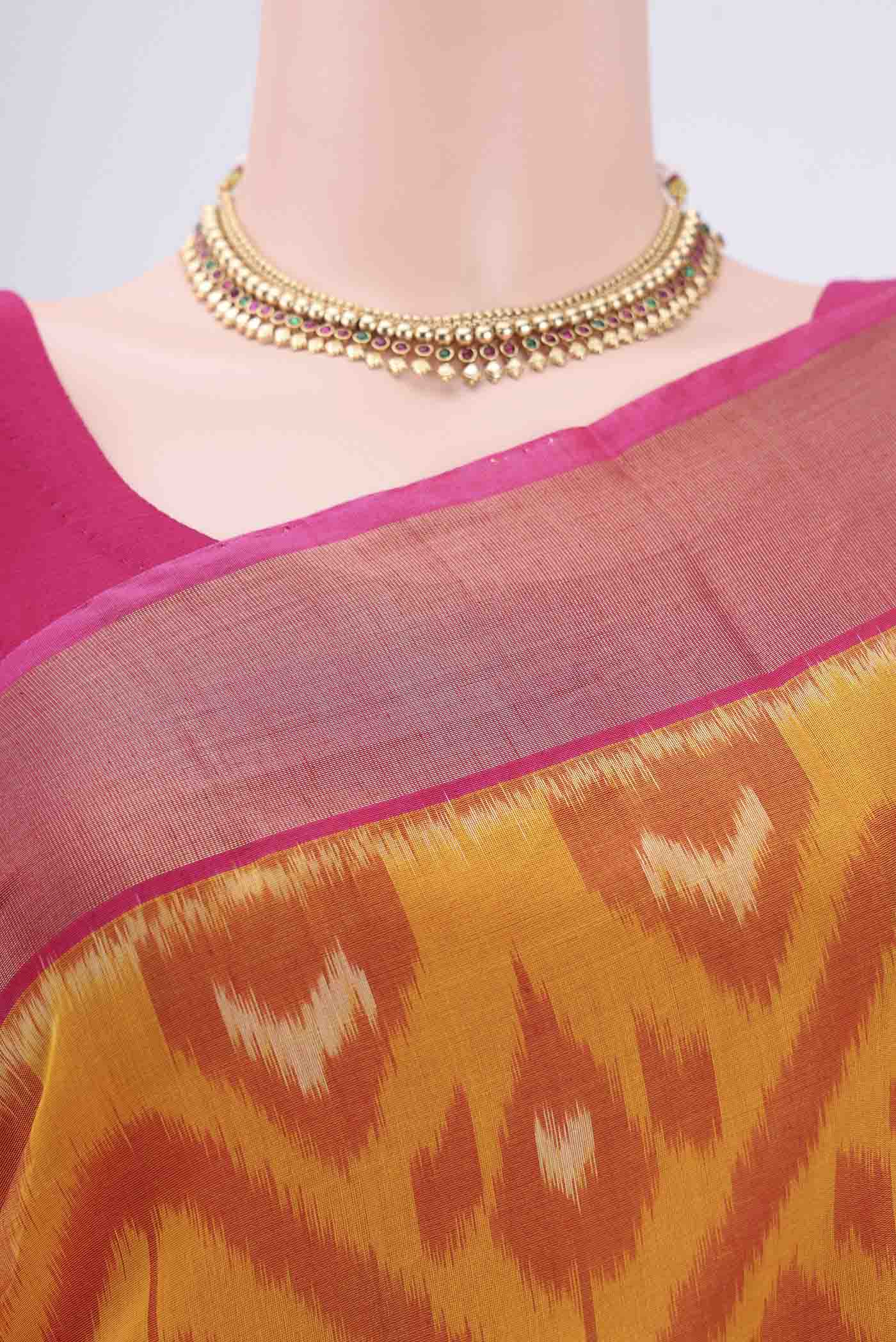 Border image of Mustard Silk Cotton Saree with Ikat design on the body and Zari Border. 