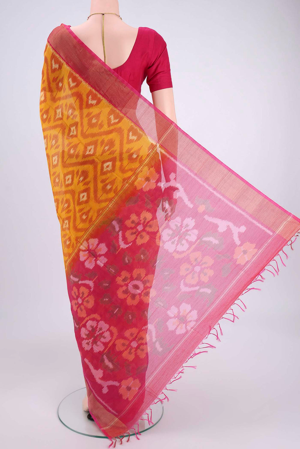 Flat view of Mustard Silk Cotton Saree with Ikat design on the body and Zari Border. 