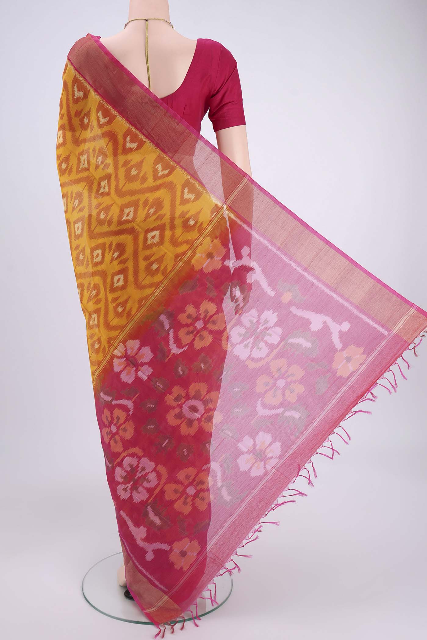 Flat view of Mustard Silk Cotton Saree with Ikat design on the body and Zari Border. 