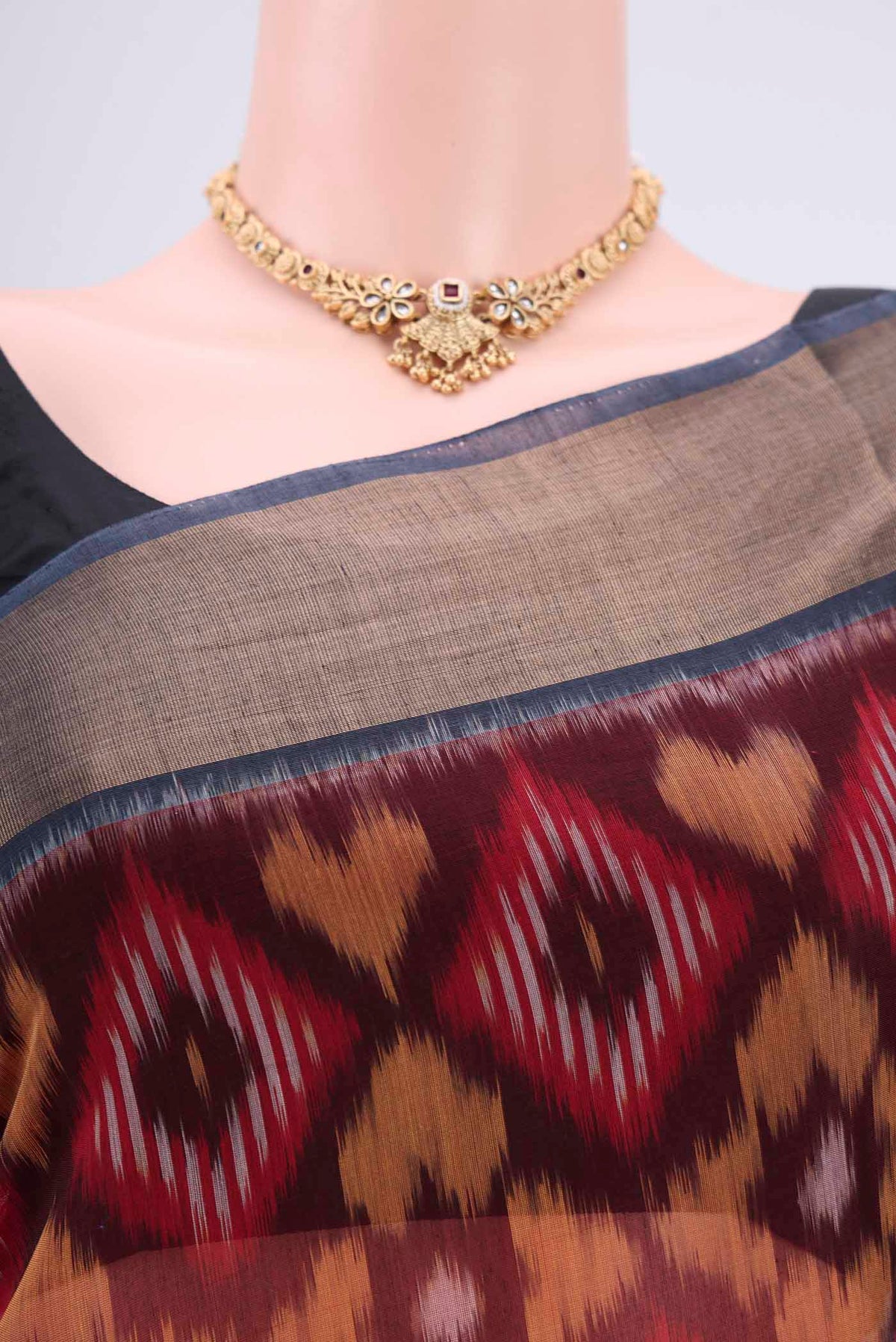 Border image of Maroon Silk Cotton Saree with Ikat design on the body and Zari Border. 