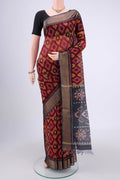 Maroon Silk Cotton Saree with Ikat design on the body and Zari Border.  displayed on a mannequin