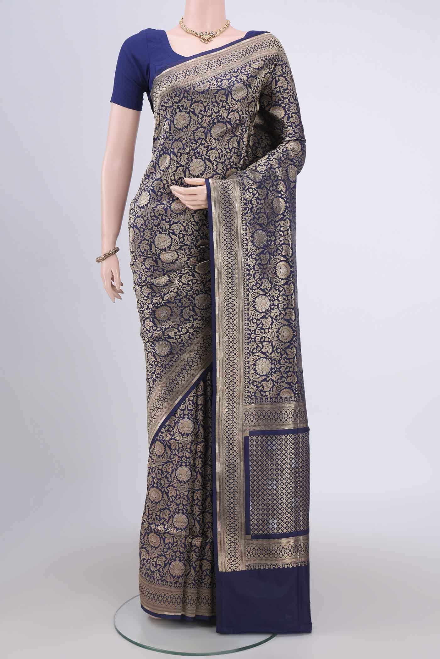 Navy Blue Banarasi Jamavar Saree with Zari Brocade on the body and Zari Border.  displayed on a mannequin