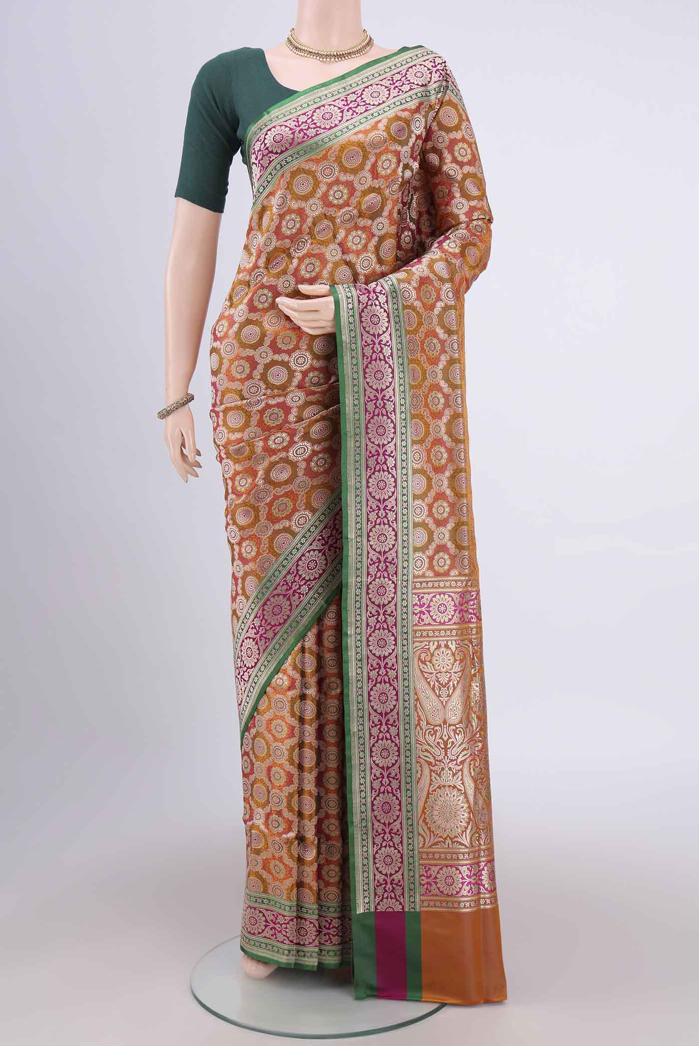 Orange Banarasi Jamavar Saree with Zari Brocade on the body and Zari Border.  displayed on a mannequin