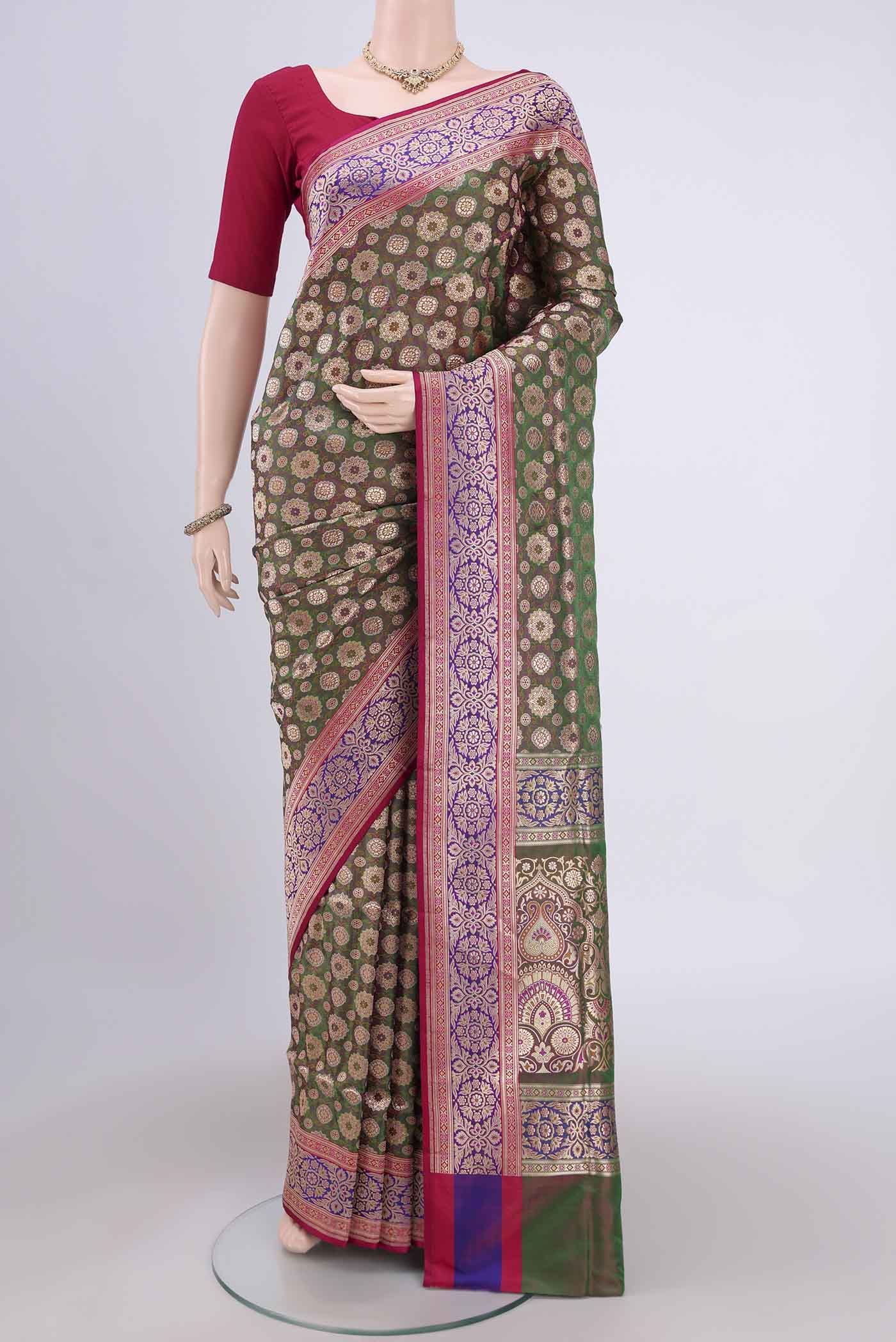 Green Banarasi Jamavar Saree with Zari Brocade on the body and Zari Border.  displayed on a mannequin