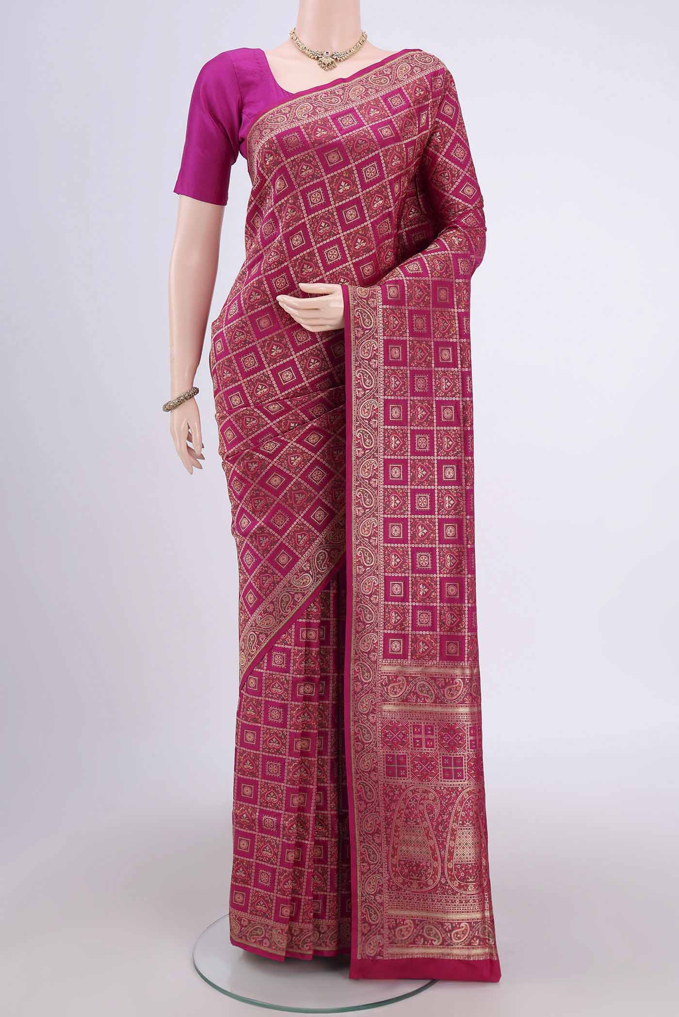 Rani Pink Banarasi Jamavar Saree with Checked design on the body and Zari Border.  displayed on a mannequin