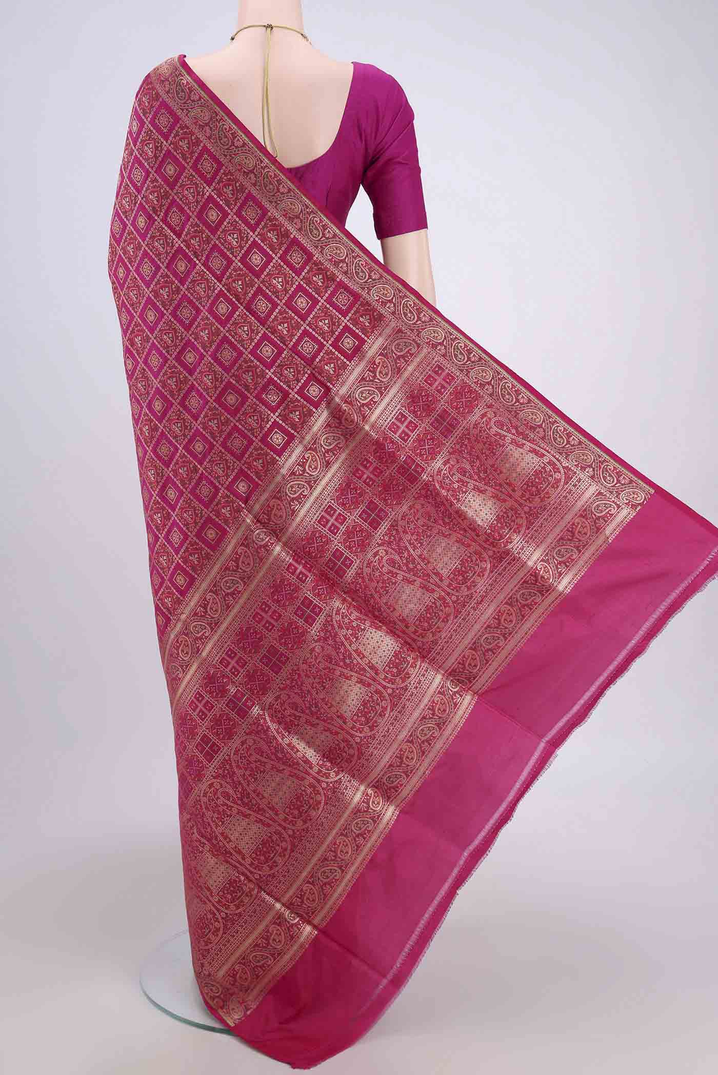 Flat view of Rani Pink Banarasi Jamavar Saree with Checked design on the body and Zari Border. 