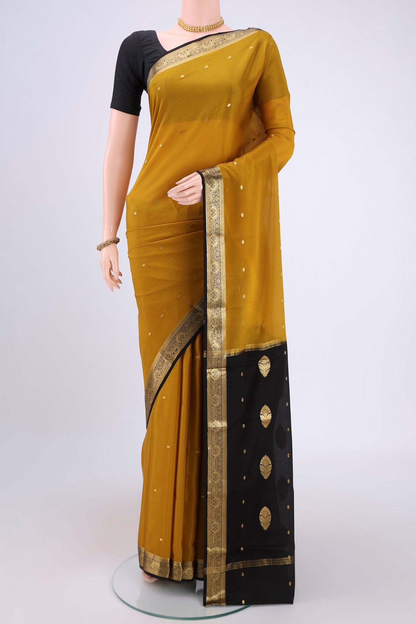 Yellow Mysore Crepe Saree with Plain Body and Zari Border.  displayed on a mannequin