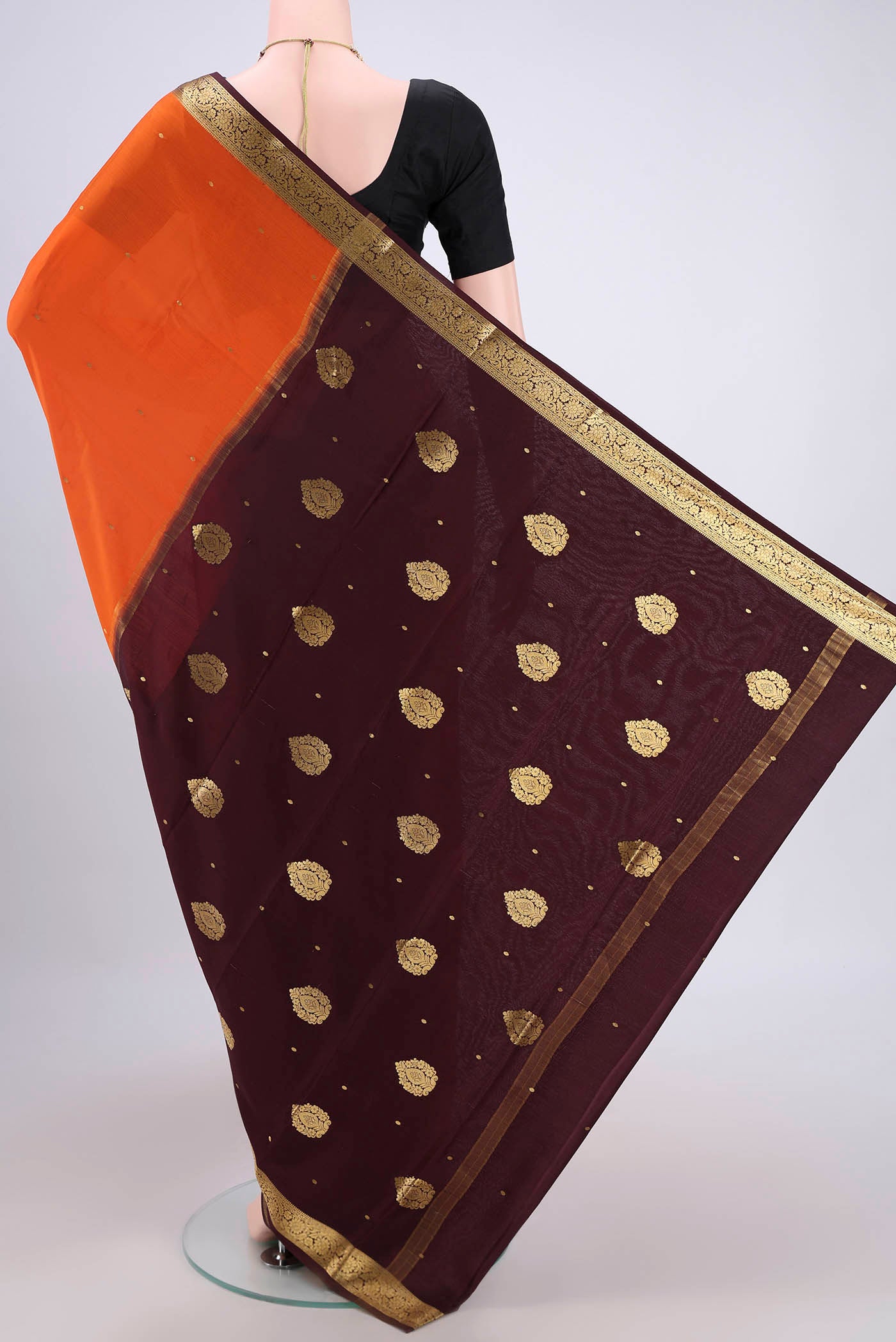 Flat view of Orange Mysore Crepe Saree with Zari Butta on the body and Zari Border. 