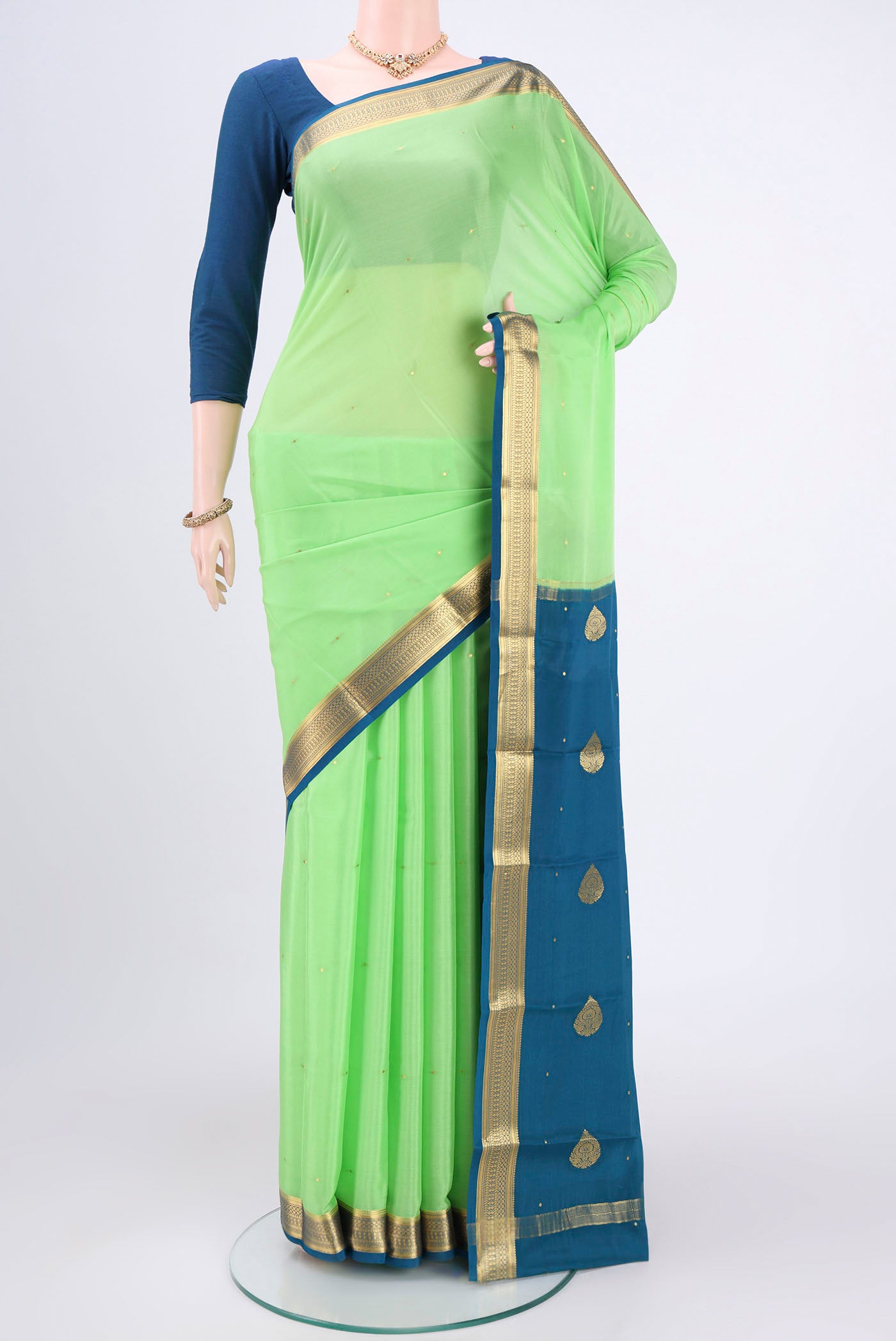Parrot Green Mysore Crepe Saree with Plain Body and Zari Border.  displayed on a mannequin