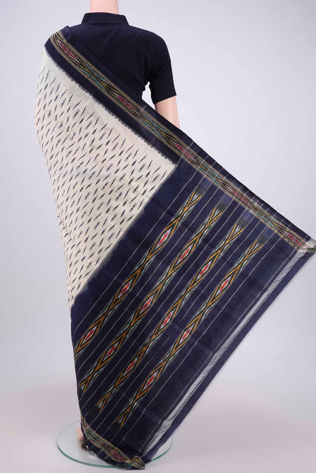Flat view of Off White Pochampally Silk Saree with Ikat design on the body and Ikat Border. 