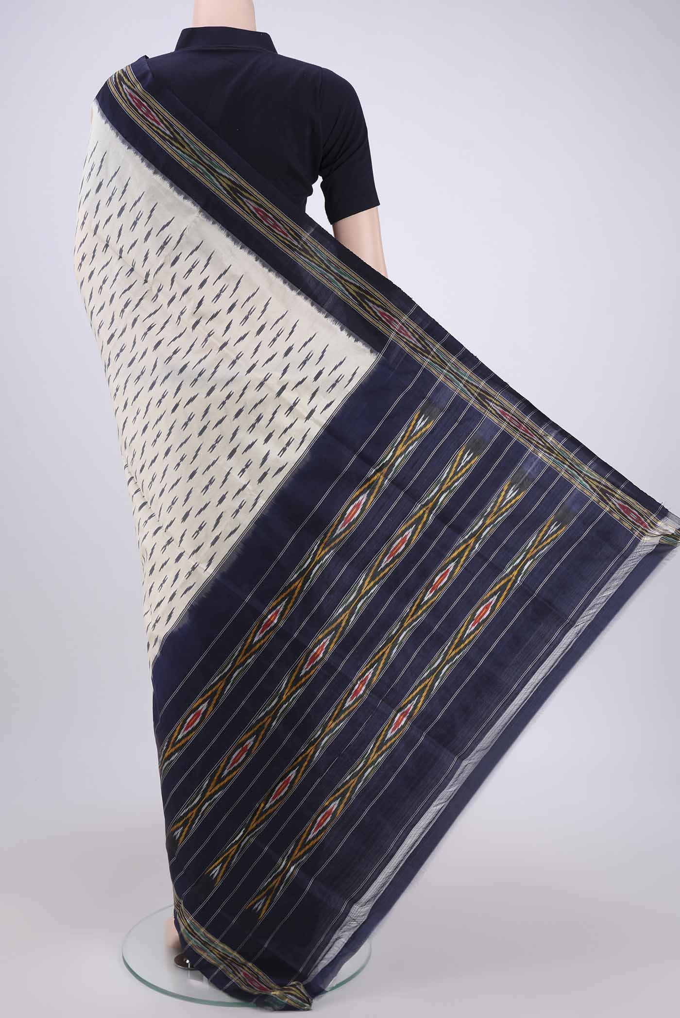 Flat view of Off White Pochampally Silk Saree with Ikat design on the body and Ikat Border. 