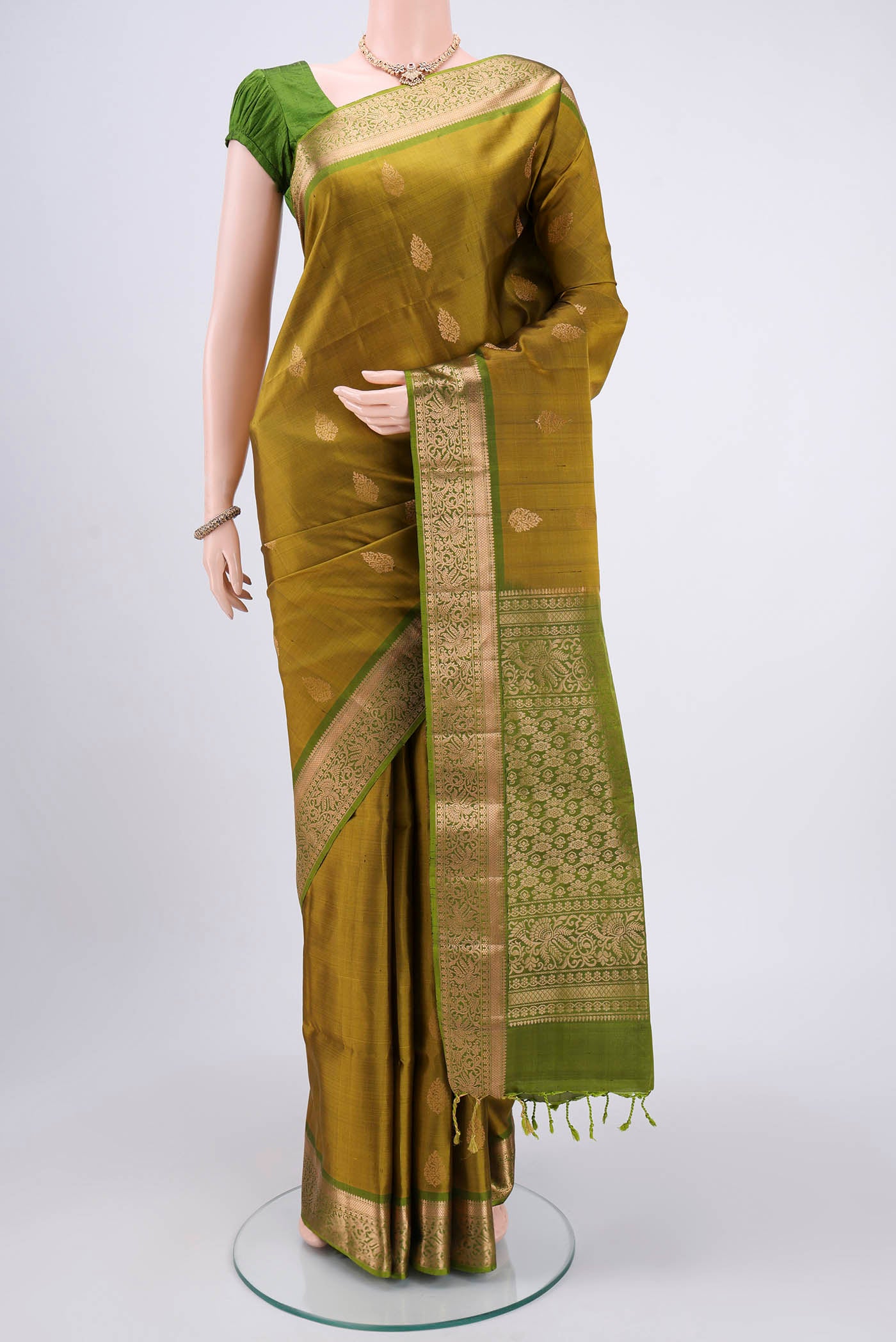 Mehandi Green Bangalore Silk Saree with Zari Butta on the body and Zari Border.  displayed on a mannequin
